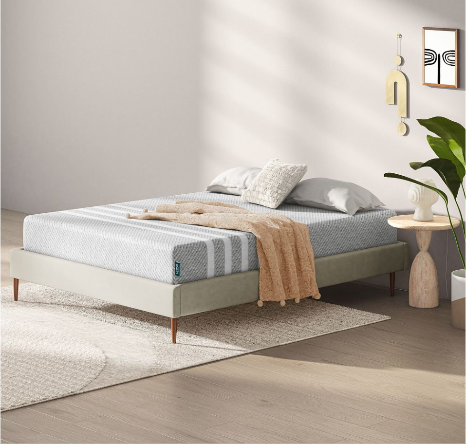 The Leesa Original on display in a bright room with a blanket, pillows and nightstand