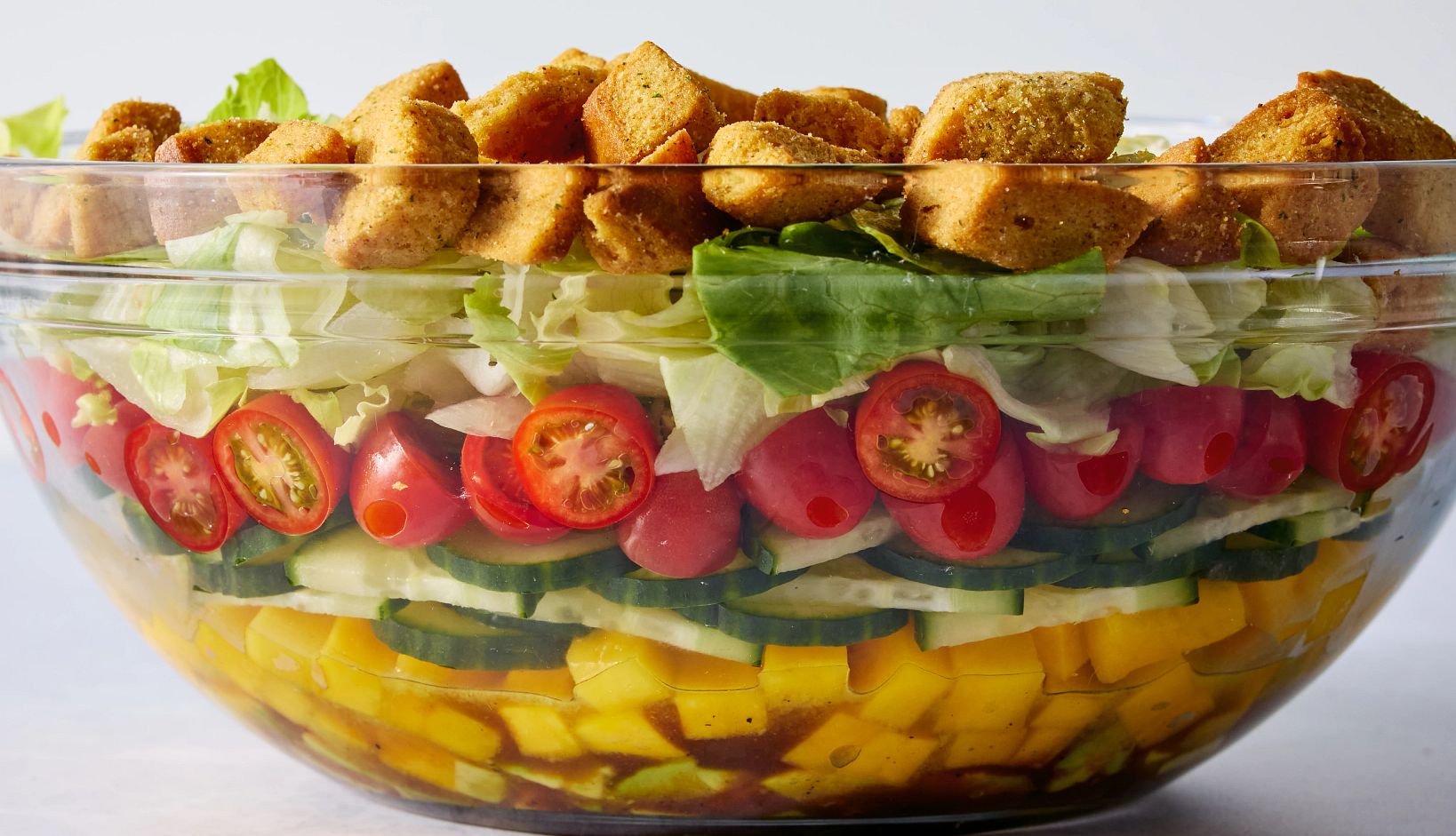 Hoda Kotb’s Upside-Down Salad Hoda Kotb’s Upside-Down Salad is pictured in a serving bowl. It features layers of mangoes, cucumbers, lettuce, cherry tomatoes and croutons.