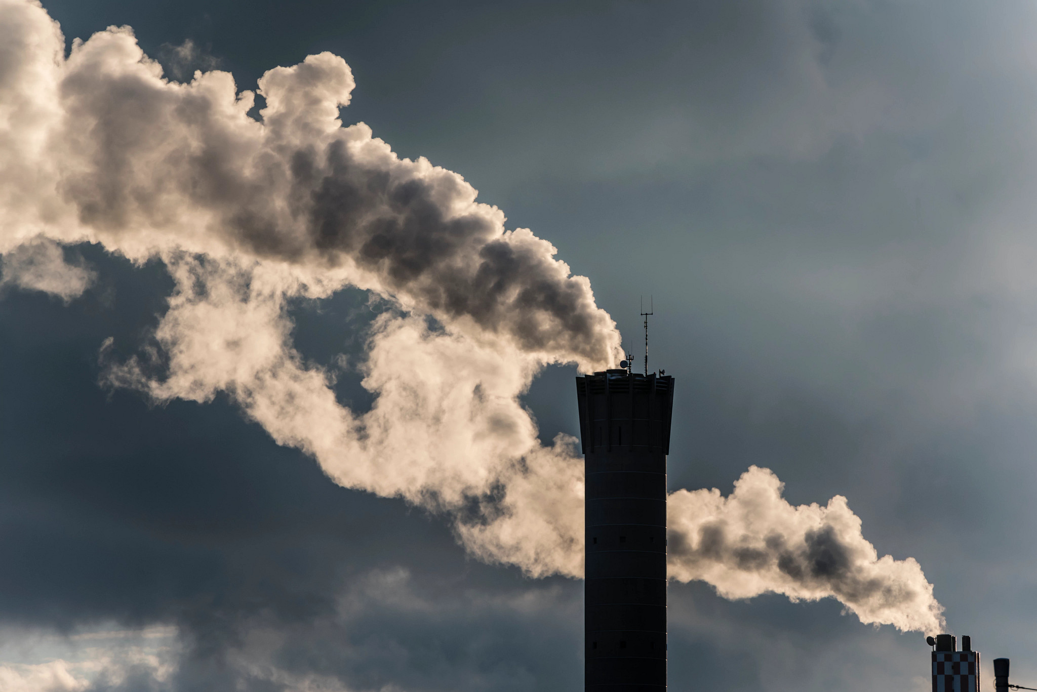 a smoke stack with smoke coming from it