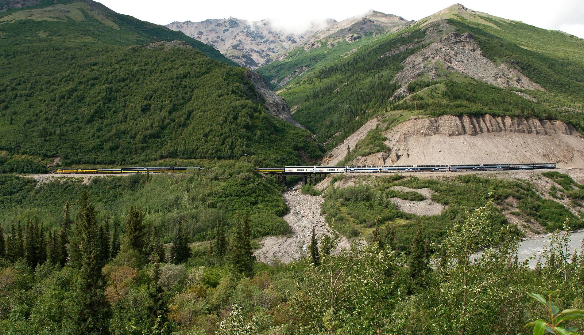 Travelers can find many affordable routes on the Alaska Railroad aerial view of a train along the Alaska Railroad