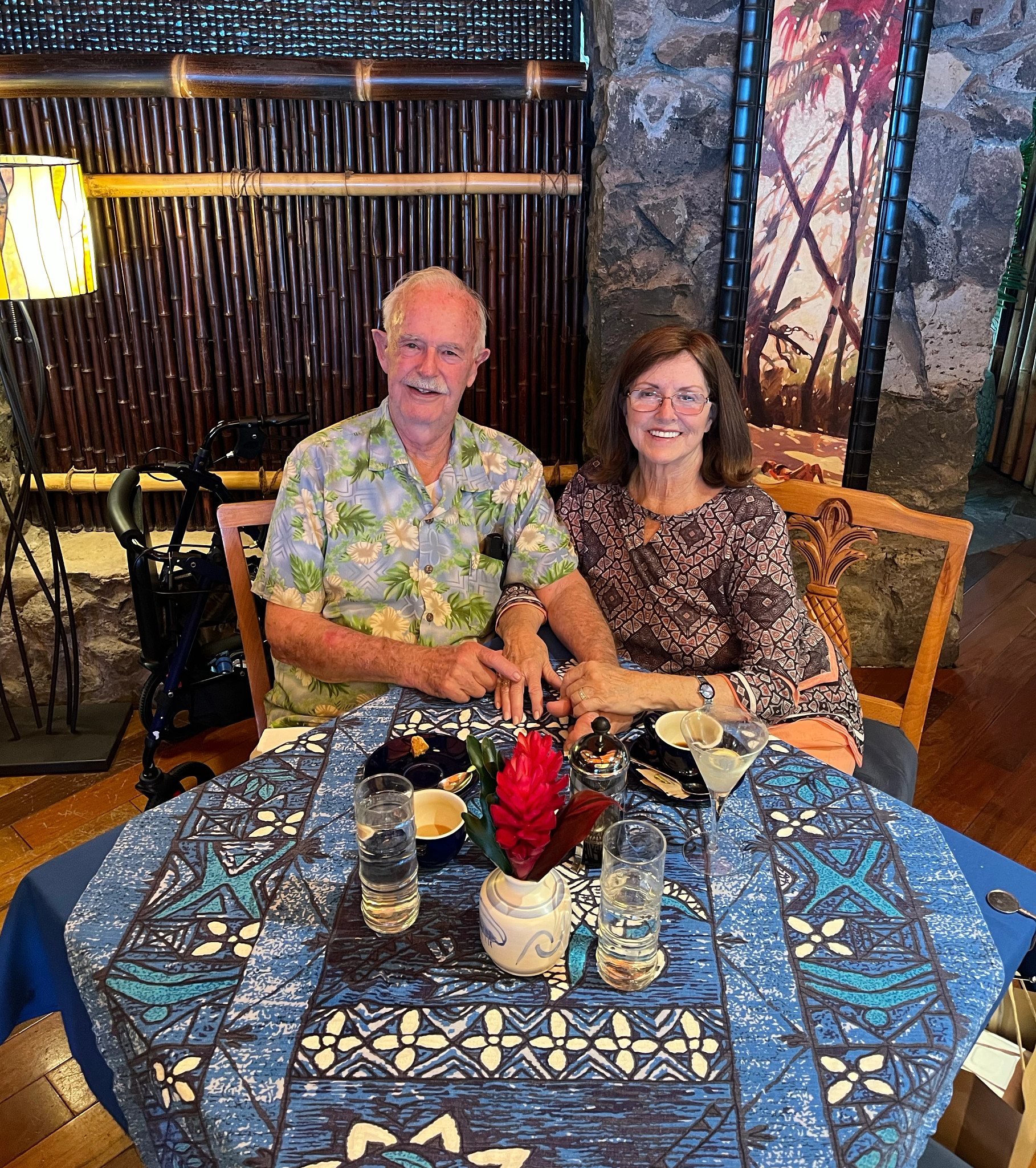 Bob and Barbara in Hawaii enjoying a special meal in a tropical setting.