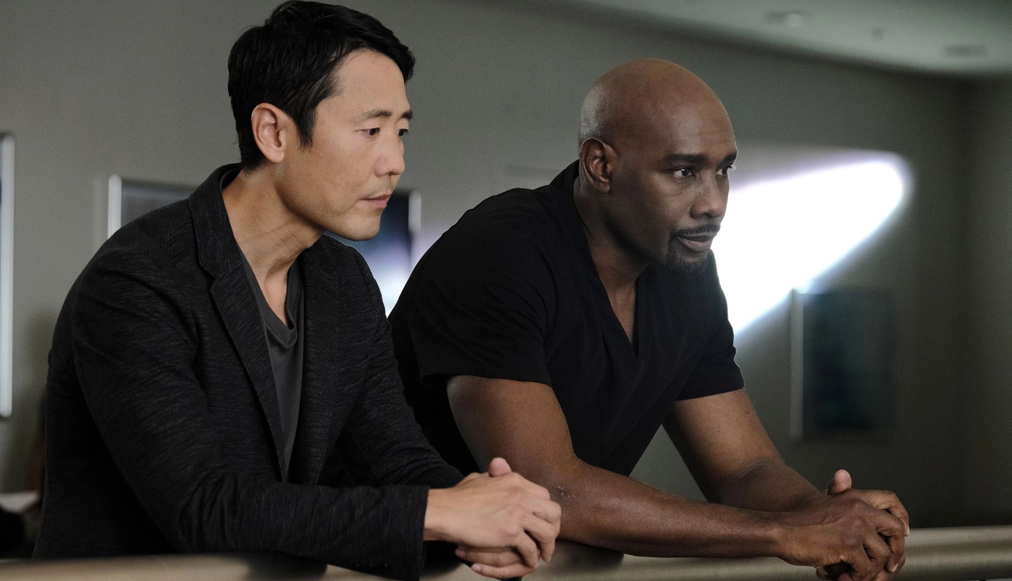 Morris Chestnut intense exchange A study in contrasts, dark tones and thoughtful expressions, suggesting a complex narrative.