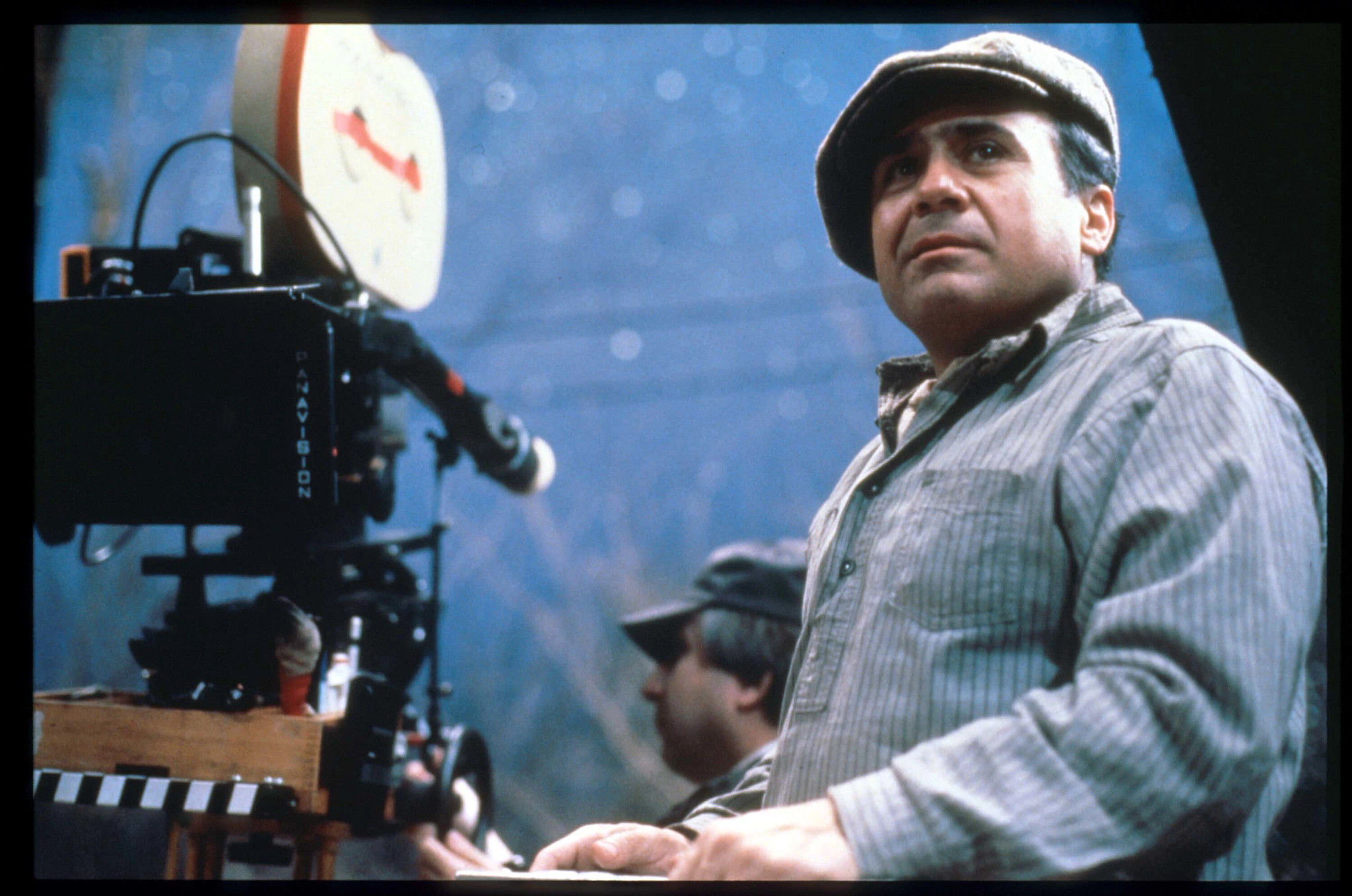 danny devito beside a movie camera on a film set
