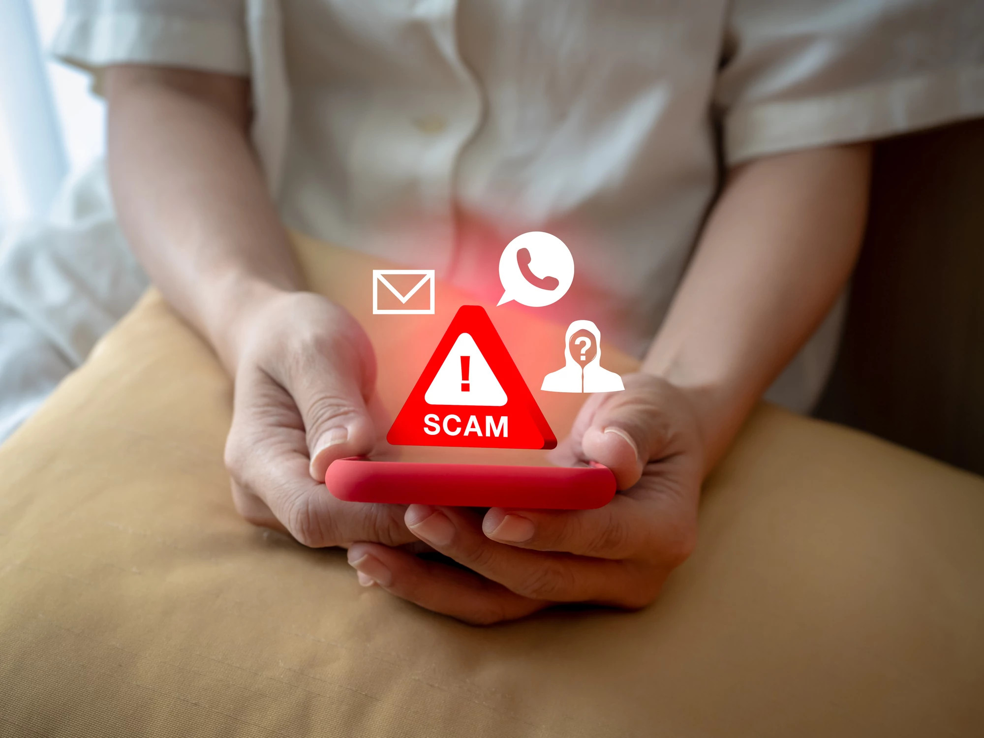 a phone with the words scam coming from it