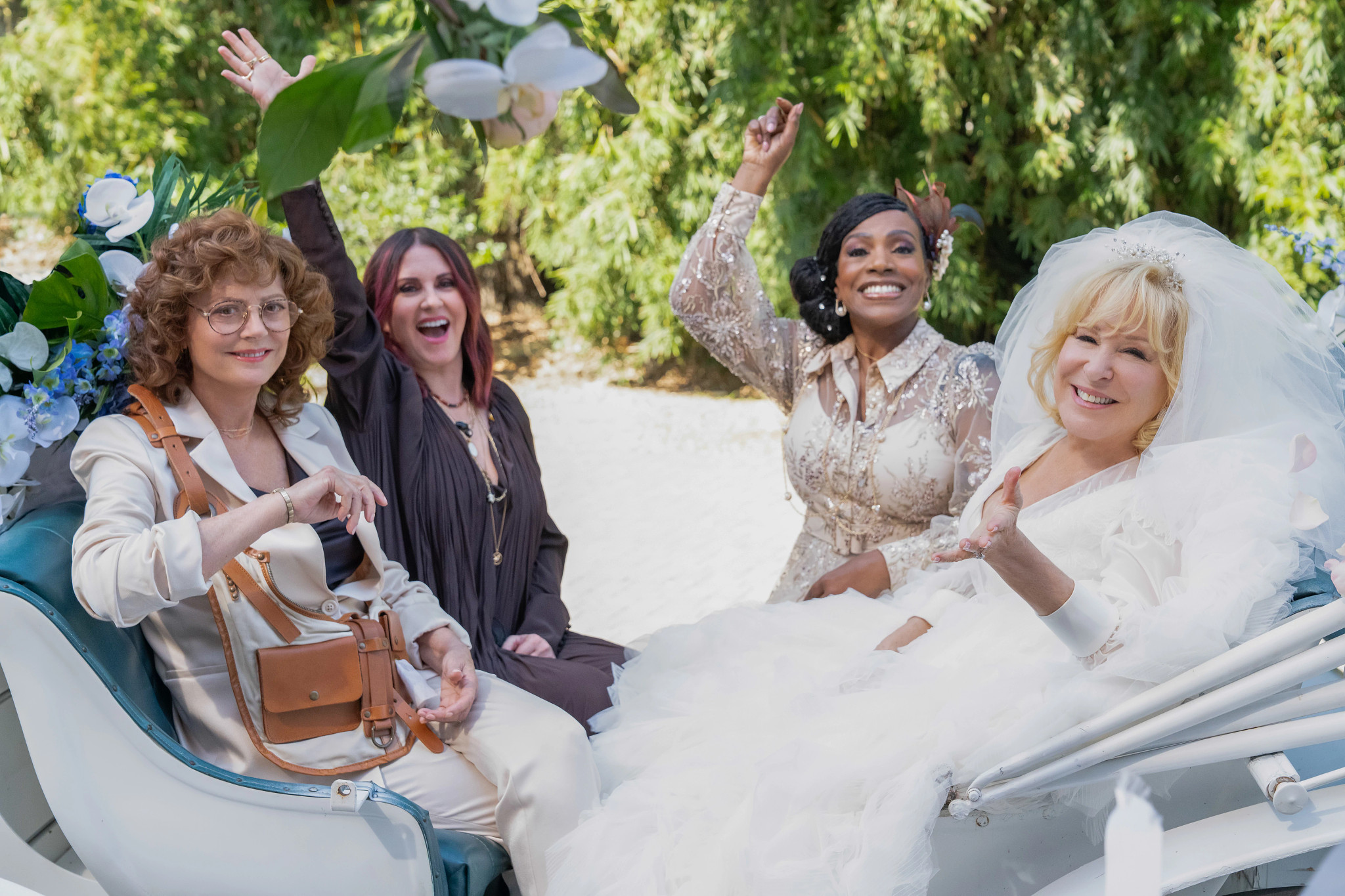 Susan Sarandon, Megan Mullally, Sheryl Lee Ralph and Bette Midler in a carriage in a still from The Fabulous Four