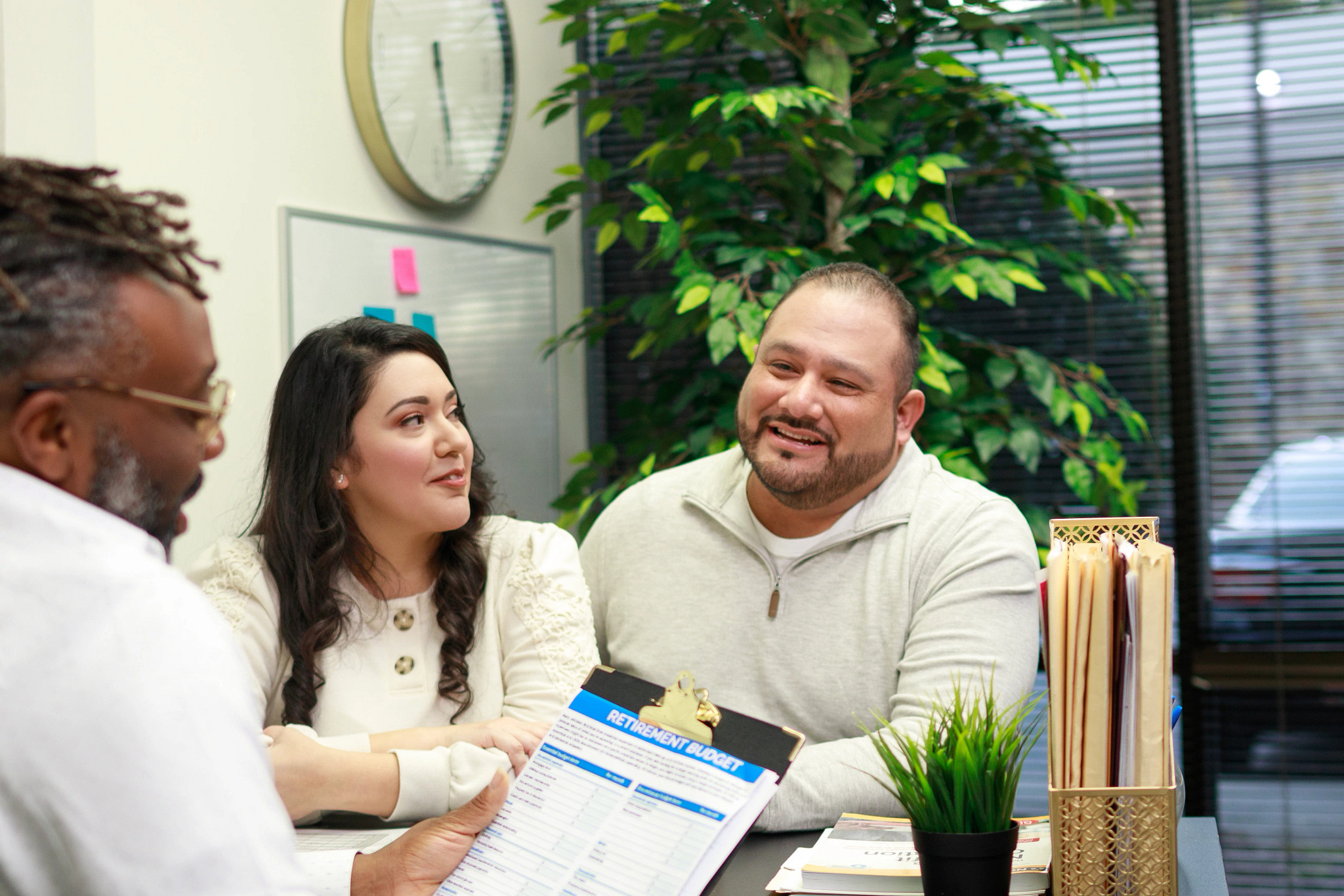 Couple looking over financial documents with Advisor