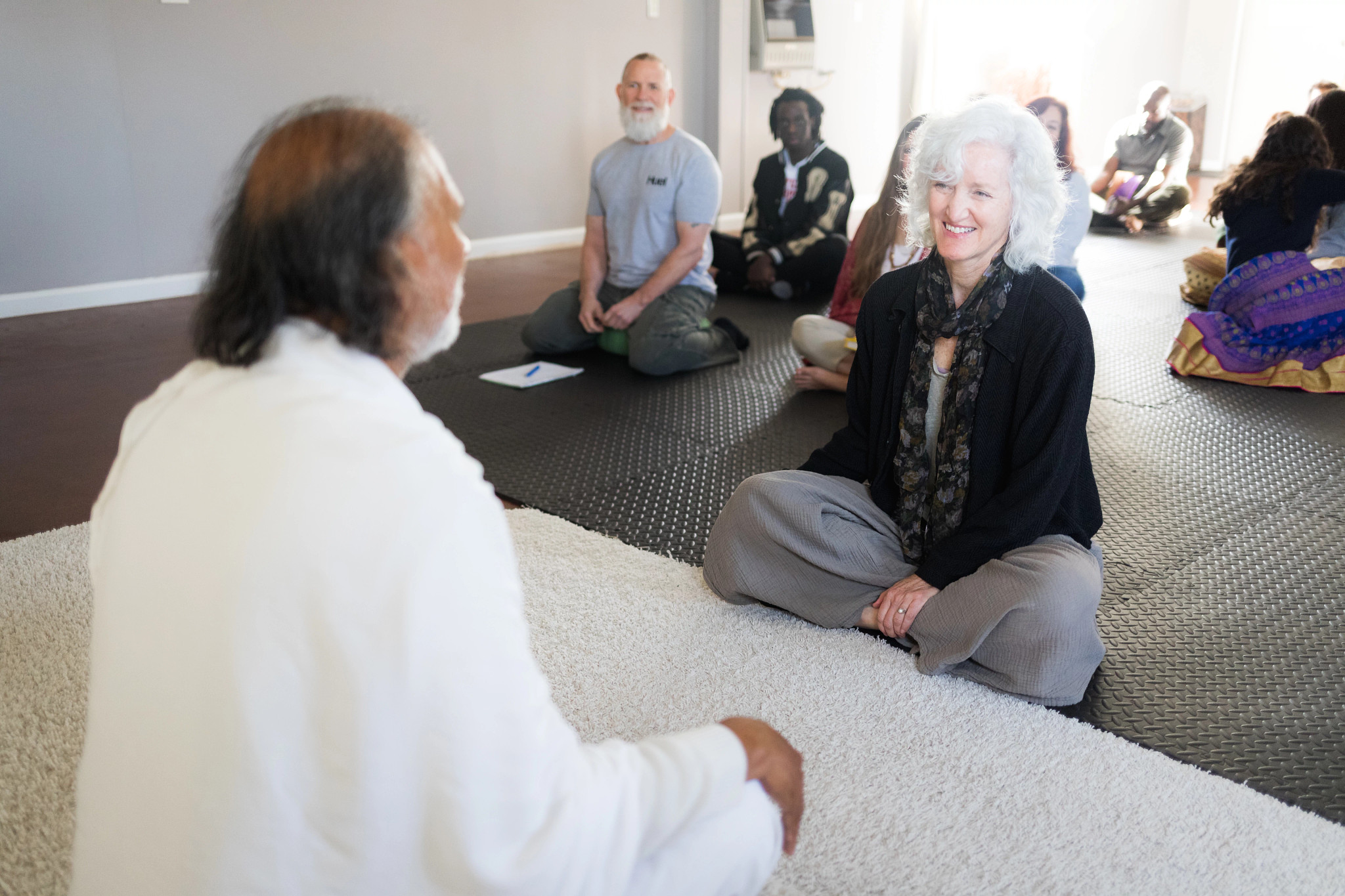 vacationers sitting on mats during a class at Siddhayatan Tirth & Spiritual Retreat in Texas