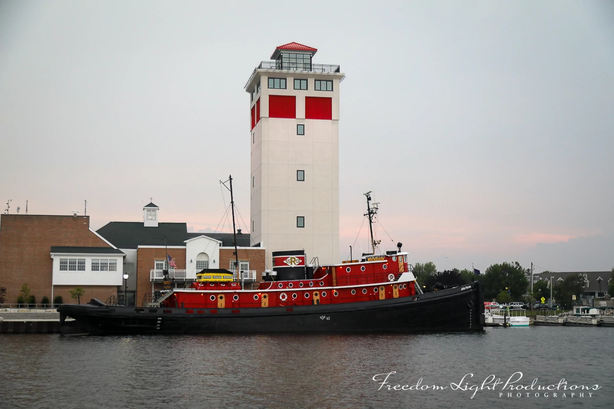 a docked boat sits outside the Jim Kress Maritime Lighthouse Tower