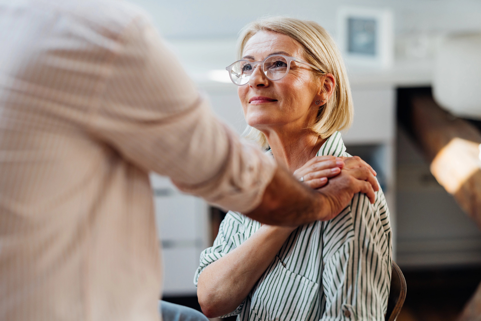 A photo shows a man gently touching a woman on the shoulder to help establish an emotional connection.