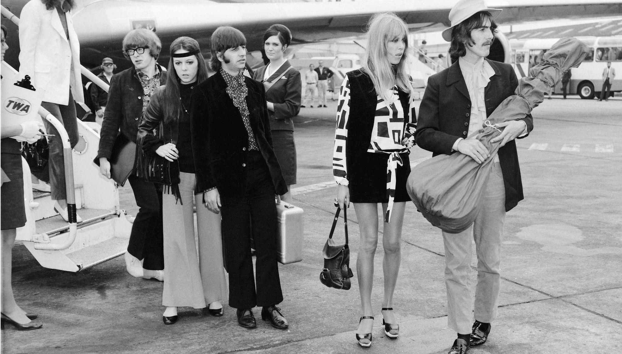 Peter Asher, Maureen and Ringo Starr, Pattie and George Harrison getting off a plane in London in 1968