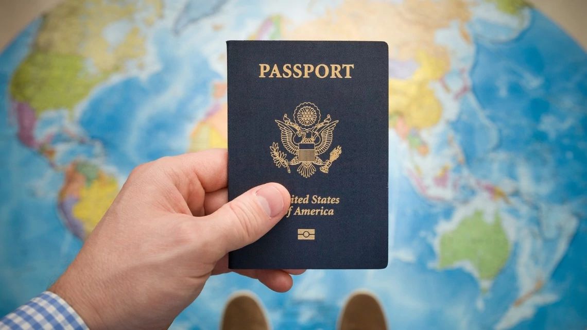 A man holding a U.S. Passport