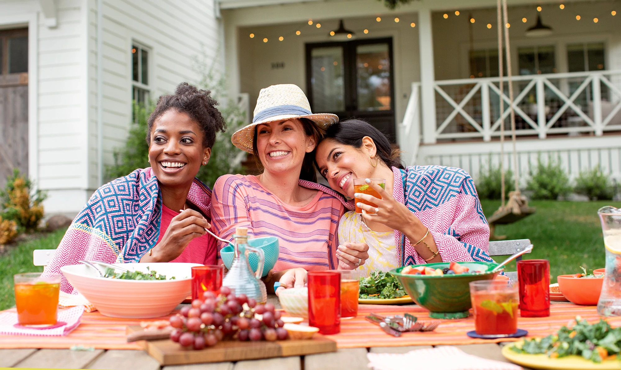 Three women outside eating lunch have fun