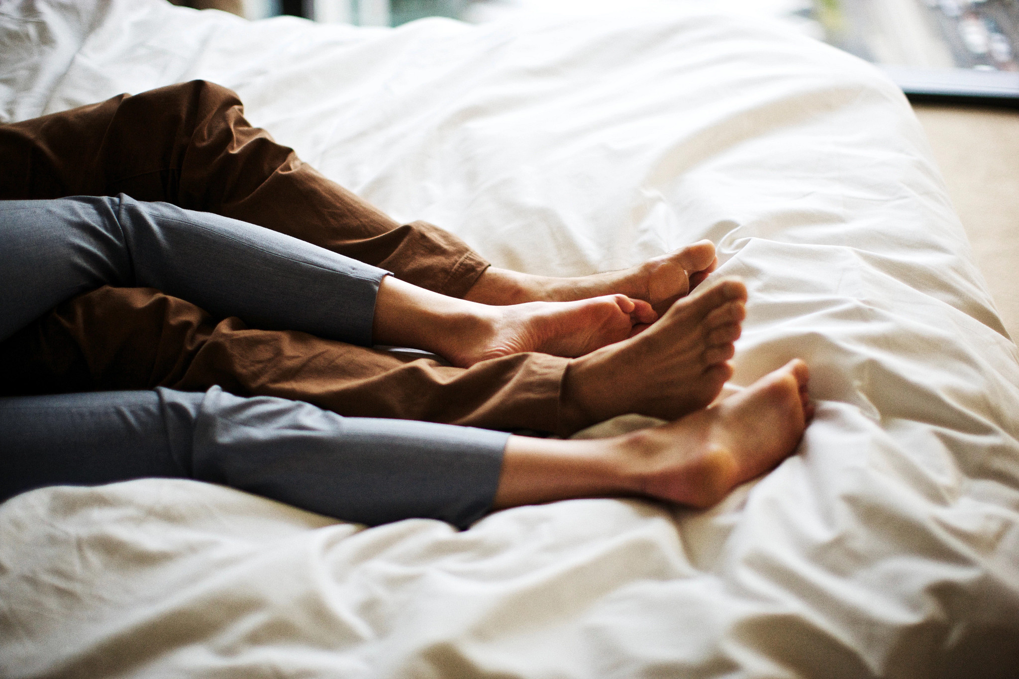 Married couple alone in bed while kids are at summer camp.