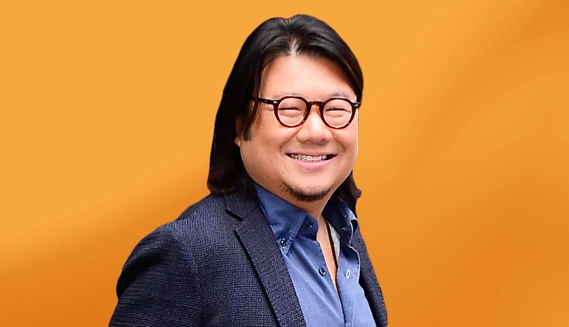 Kevin Kwan interview Kevin Kwan against yellow ombre background
