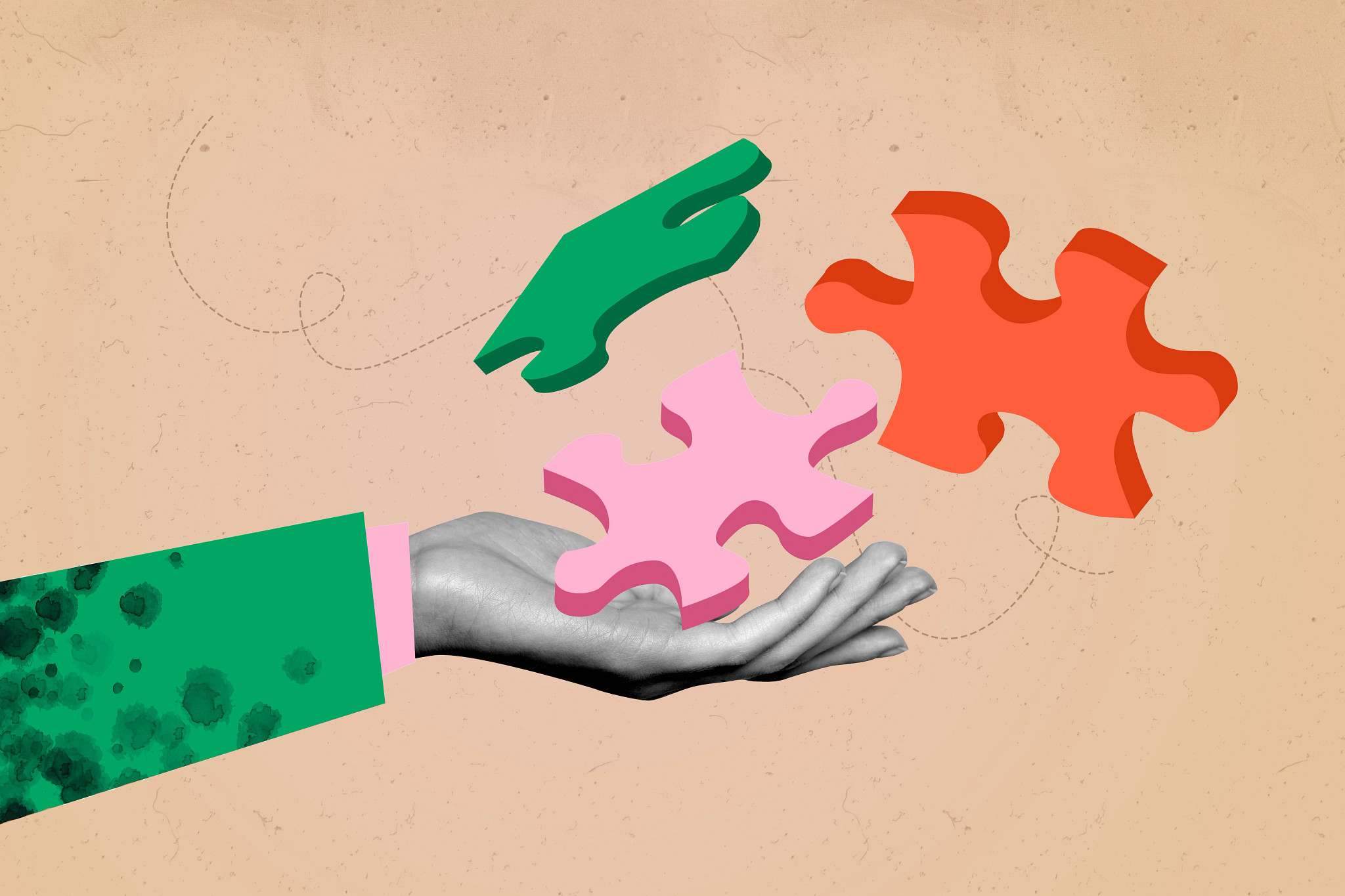 A hand holding three jigsaw puzzle pieces on a gray background.