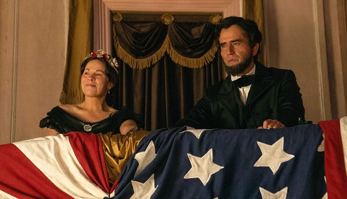 Lili Taylor and Hamish Linklater sitting next to each other in Ford's Theatre in a scene from the Apple TV+ series "Manhunt" Lili Taylor and Hamish Linklater sitting next to each other in Ford's Theatre in a scene from the Apple TV+ series "Manhunt"