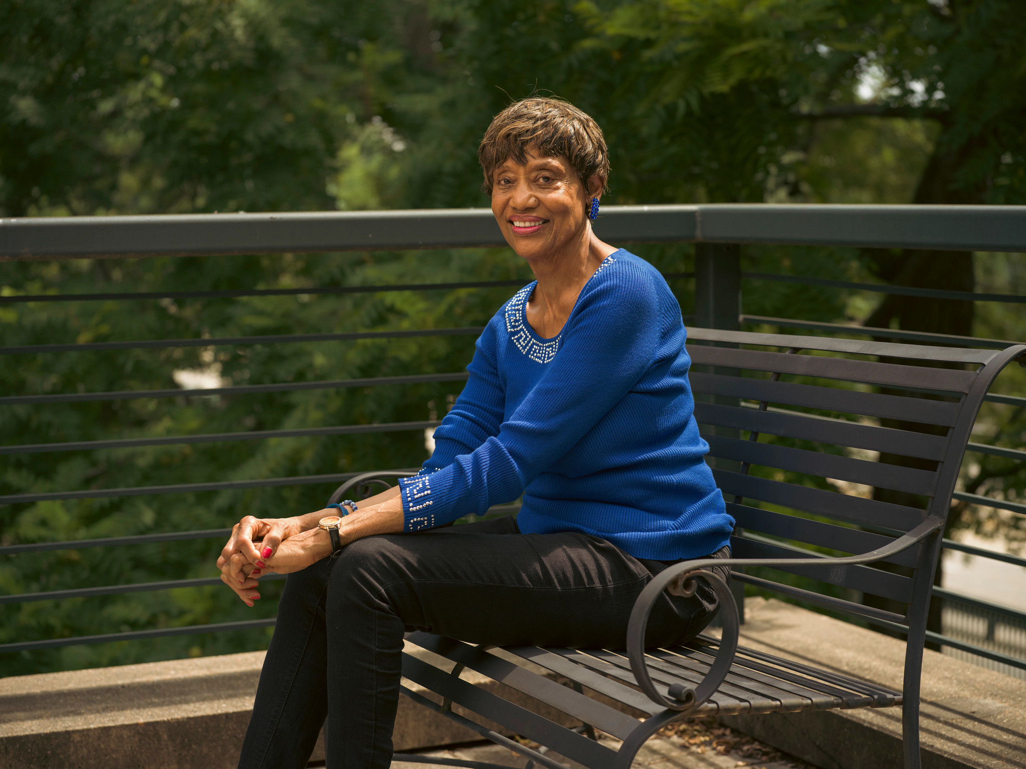 A photo shows grandparent Theresa Kelly, a retired elementary school teacher, sitting on a bench.