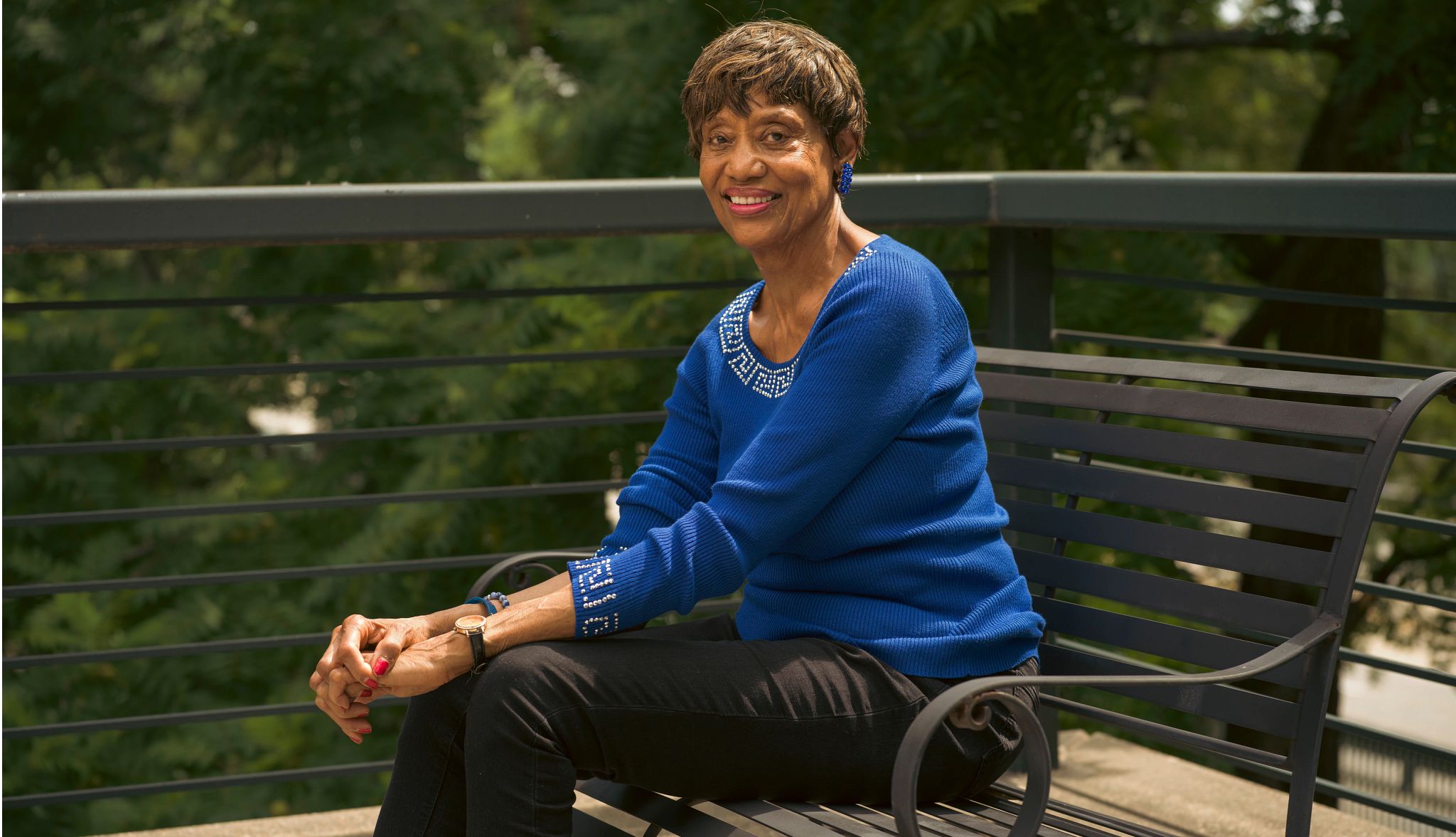 Friendship Bench Program Offers Mental Health Support A photo shows grandparent Theresa Kelly, a retired elementary school teacher, sitting on a bench.