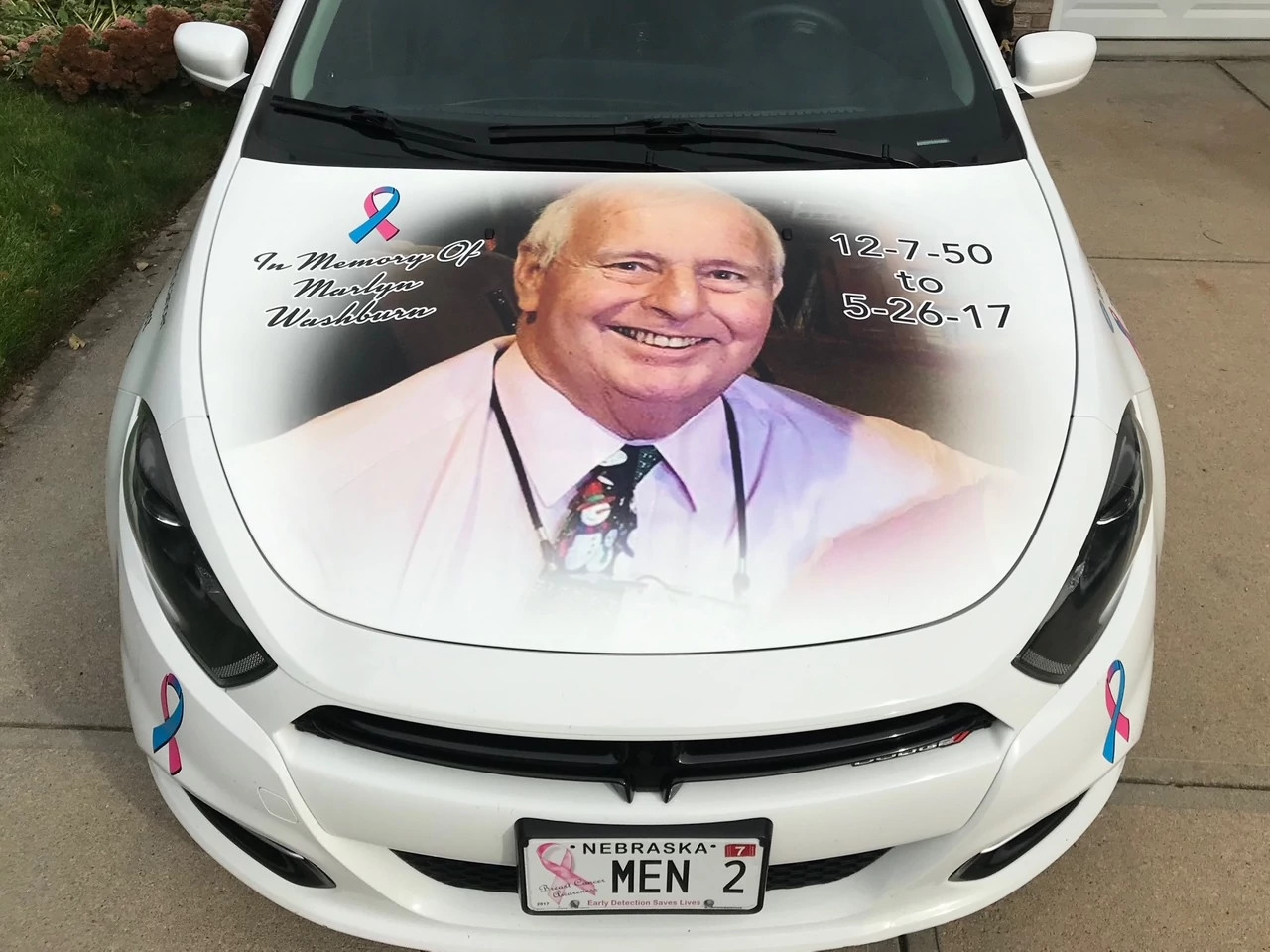 a photo of marlyn on the hood of a white car