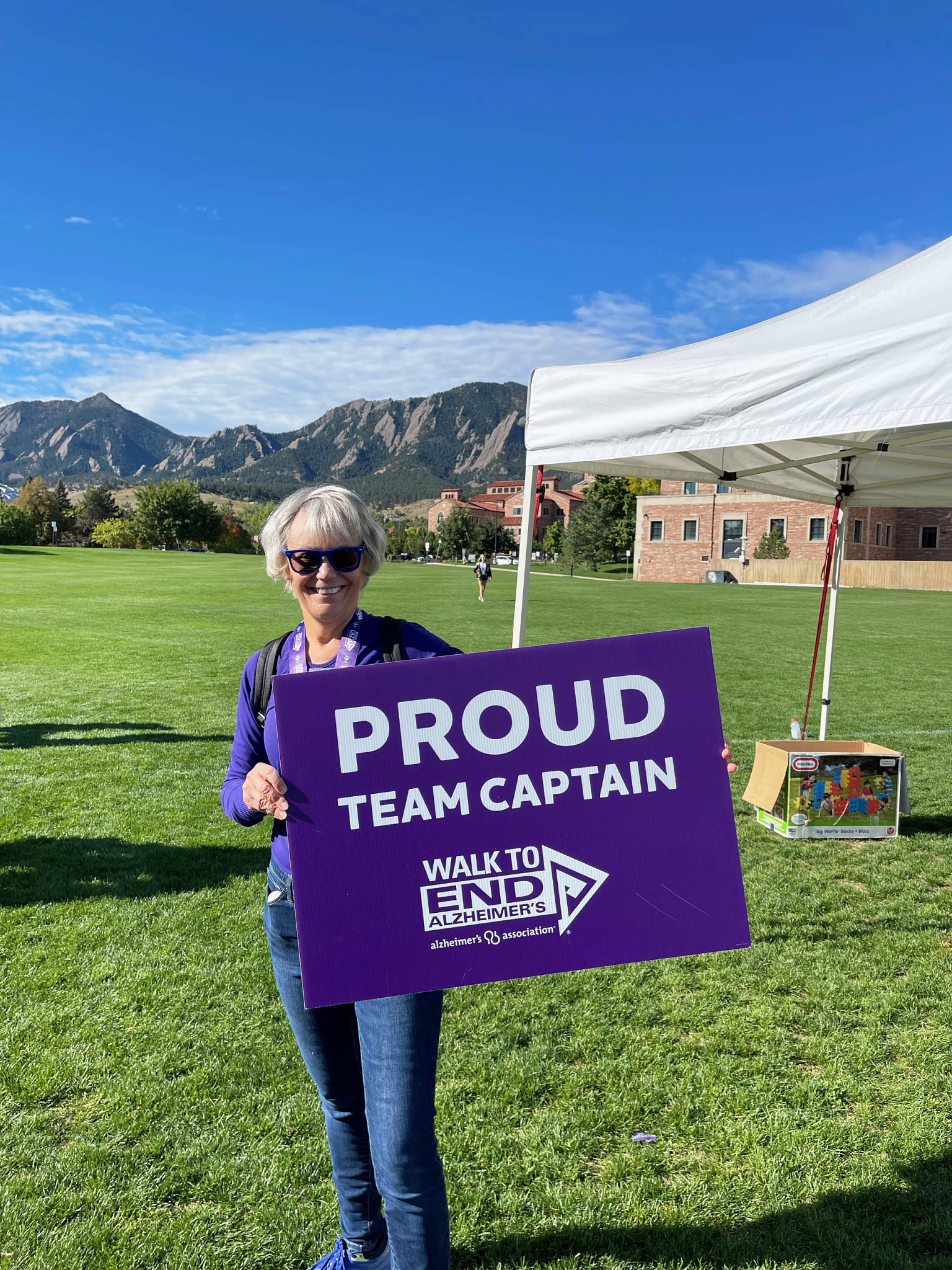 a person holding up a purple sign