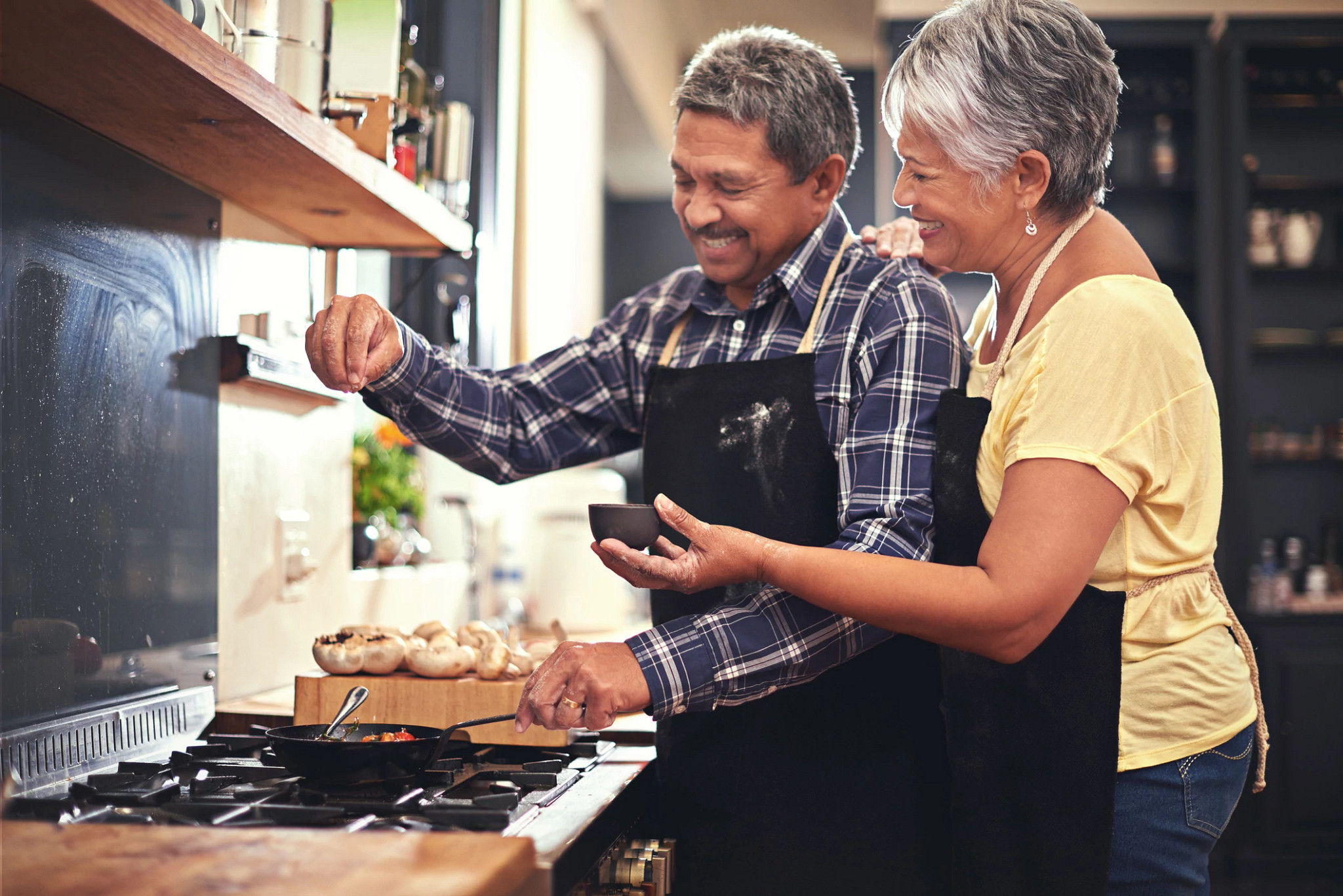 Shot of a happy senior couple cooking together at home
