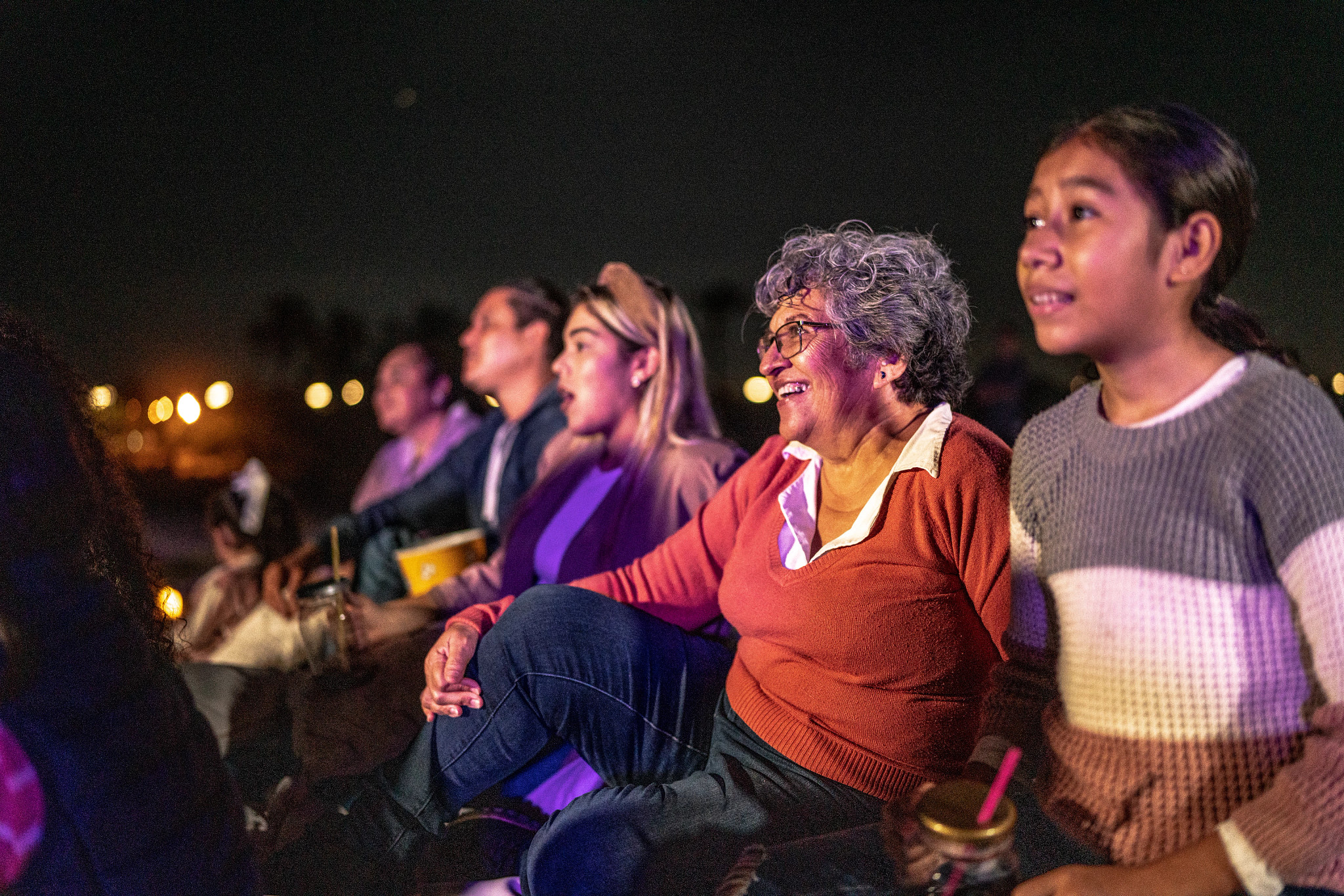 Group of people enjoying a movie at the outdoors cinema