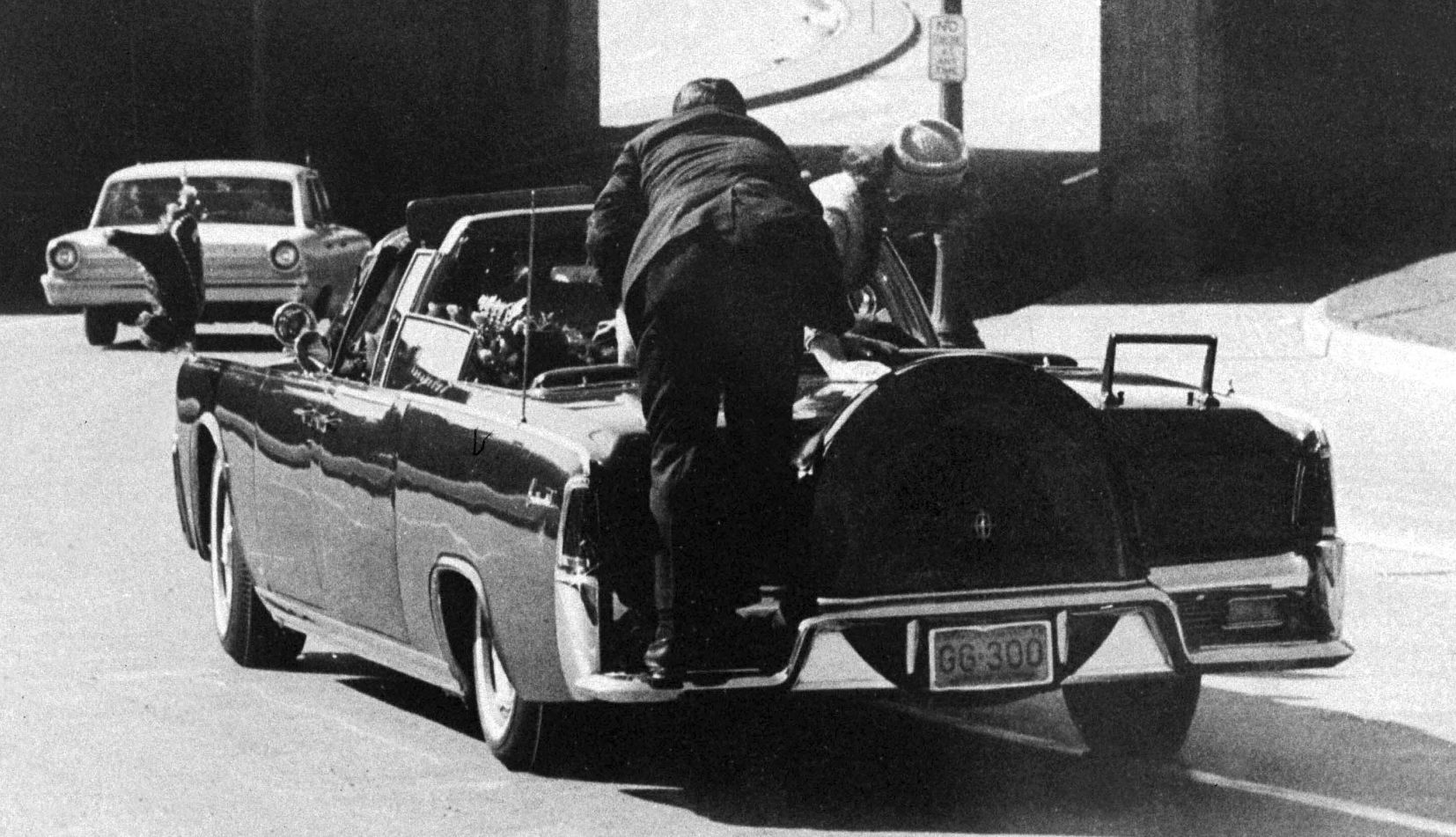 Clint Hill clint hill jumps onto the back of john f kennedy's presidential limousine