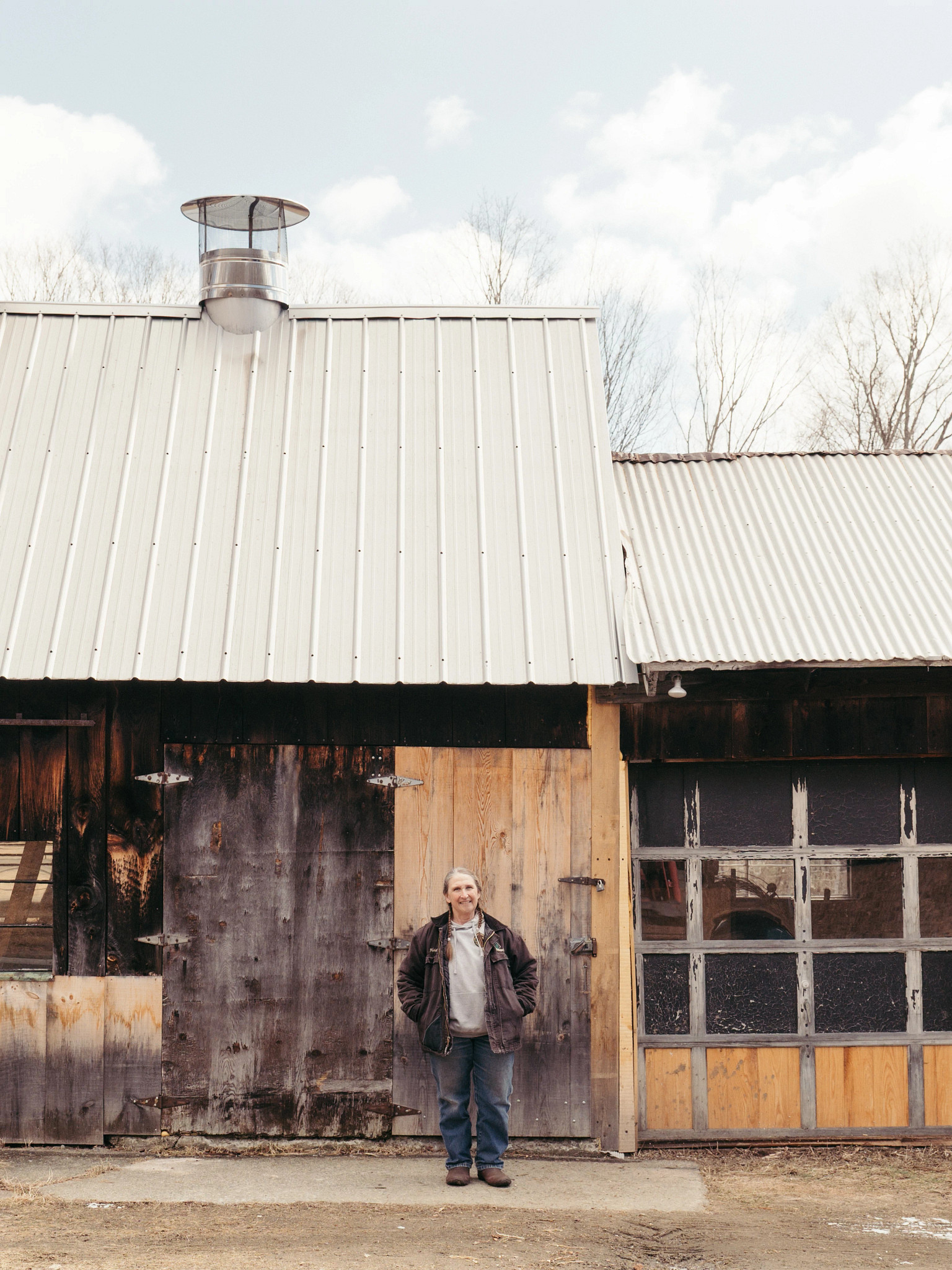 Heidi Bundy standing in front of a rustic building