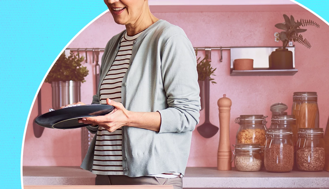 Accessible kitchen organization a person wipes a plate in front of a kitchen counter