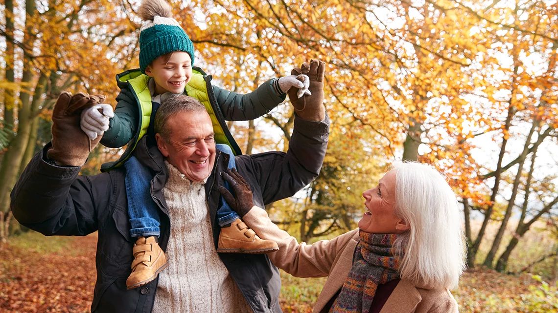 Grandparents smiling with grandkid