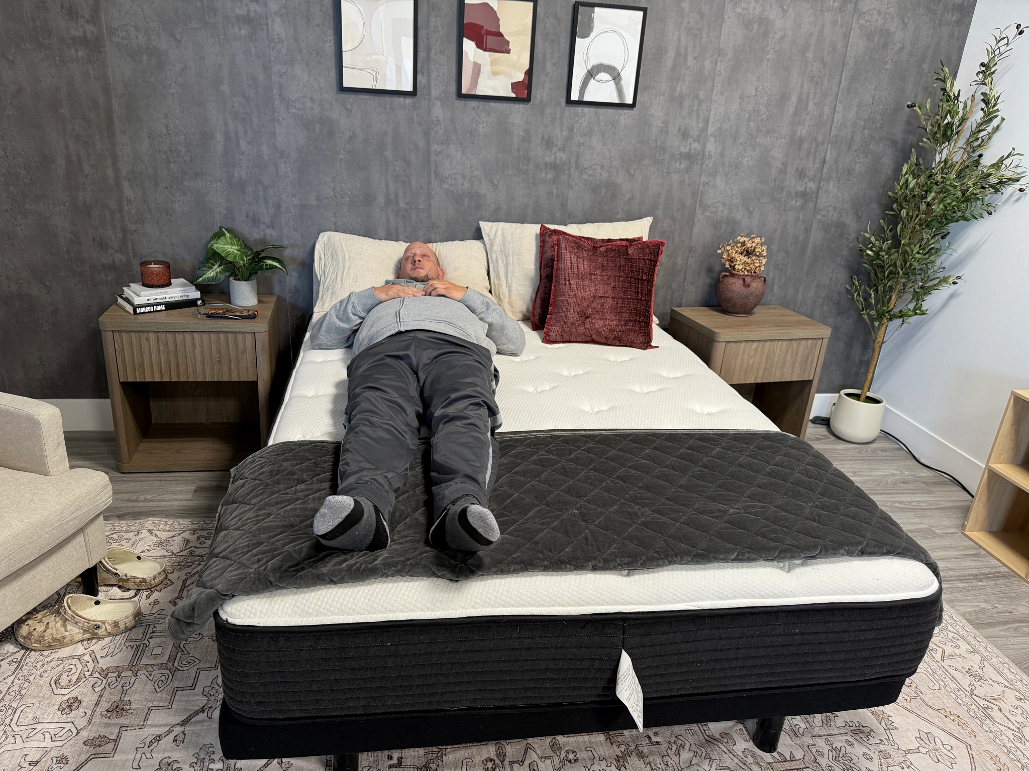 A man lying on his back on the Plank Firm Luxe mattress.