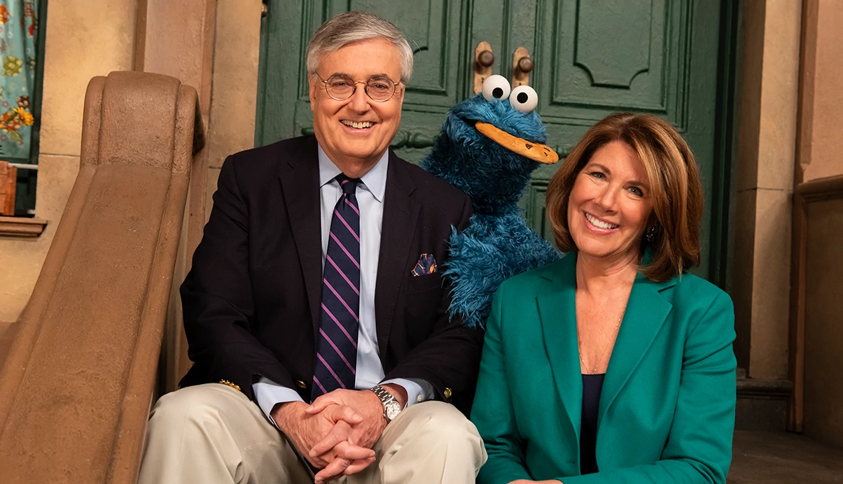 jeffrey d dunn and sherrie rollins westin posing with cookie monster on the set of sesame street