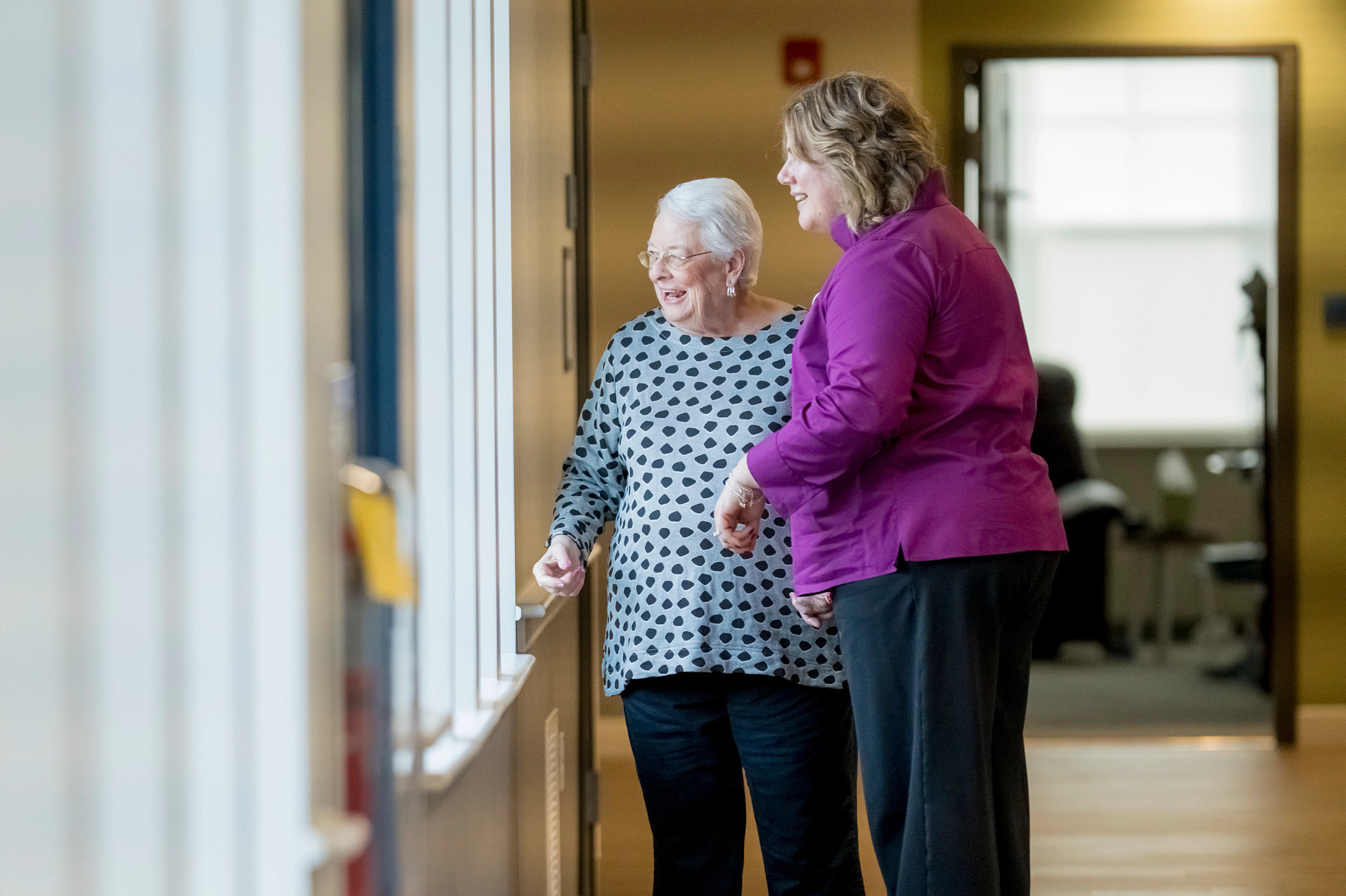 people walking and looking out a window