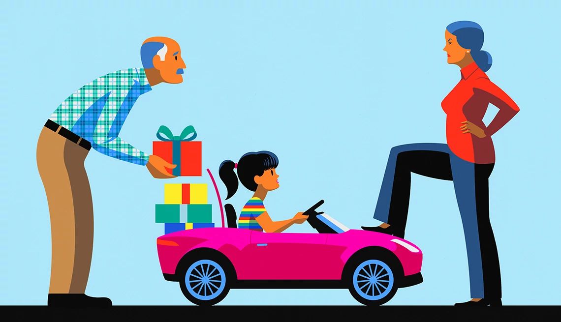 My Husband Is Spoiling Our Grandkids a grandchild sits in a toy car. a grandfather stands behind the car and places a gift inside, while a grandmother stands in front of the car with her foot on the hood.