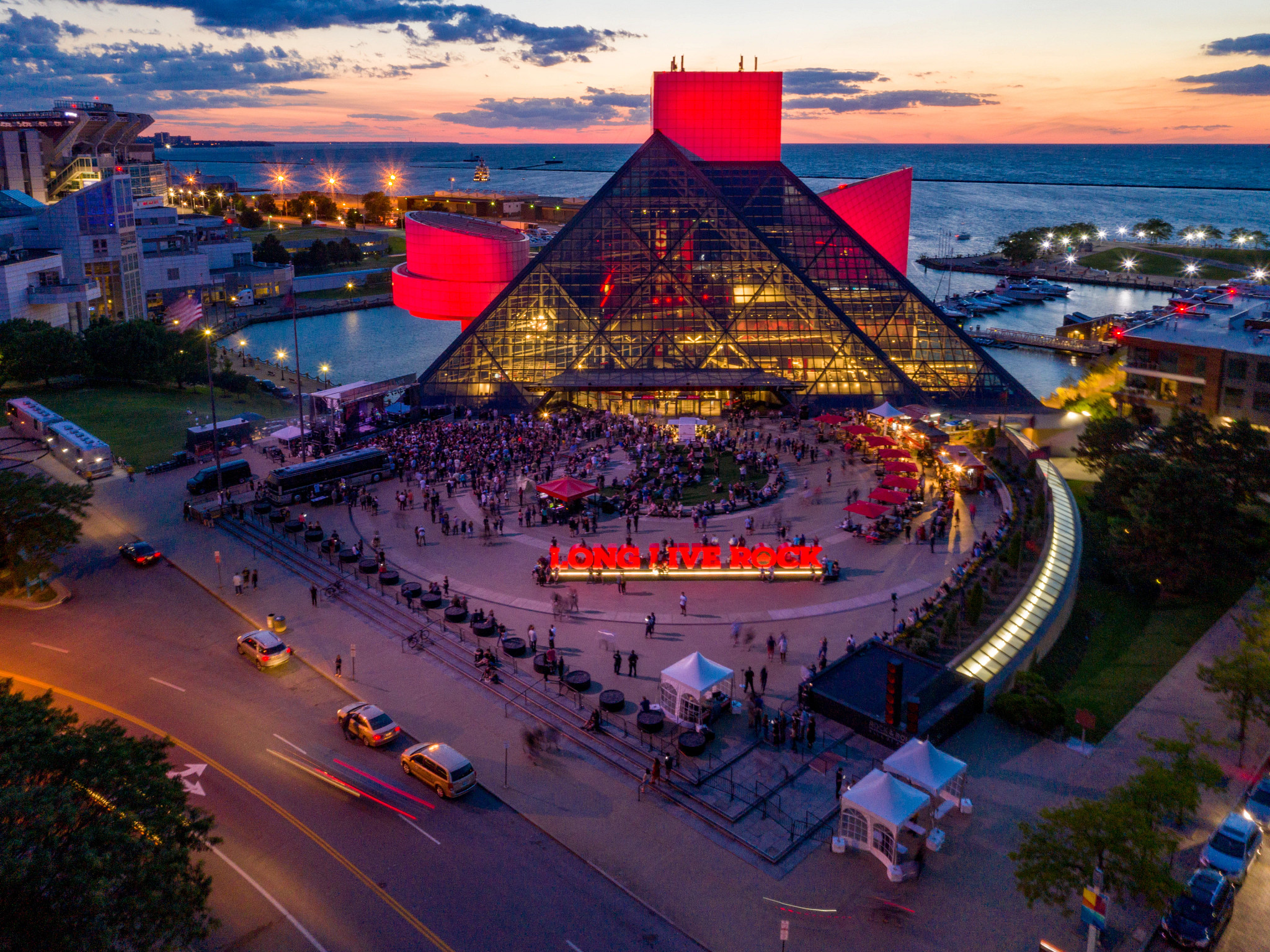 the exterior of the Rock & Roll Hall of Fame with dozens of people in the courtyard area