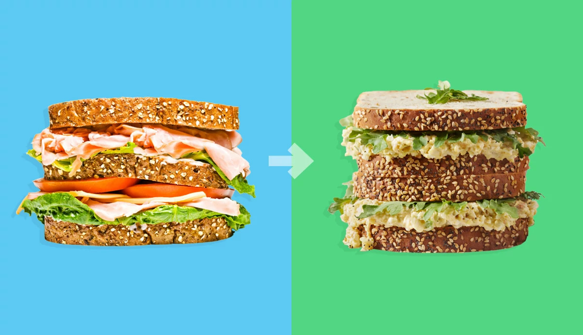 A lunchmeat sandwich next to an egg salad sandwich.