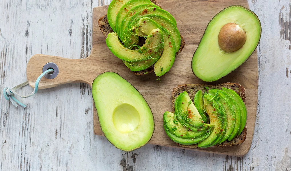 A close-up view of avocados on a cutting board