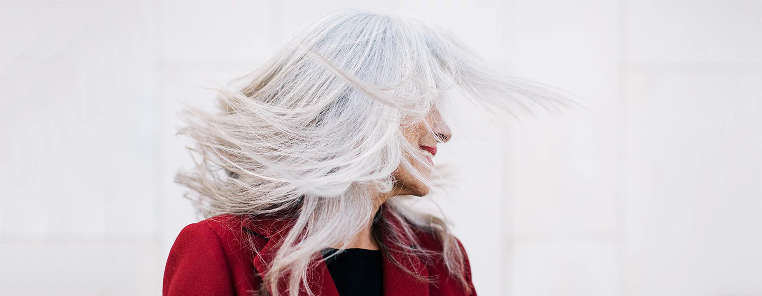 An image of a woman with long gray hair.
