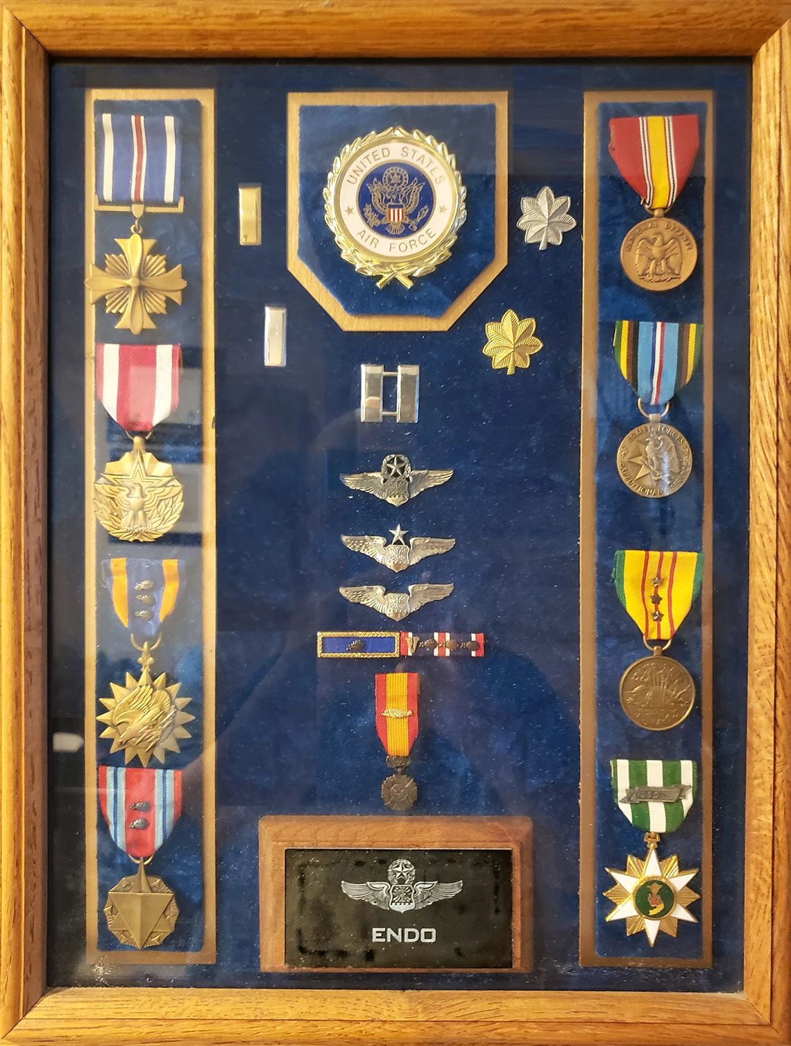 toki endo's military medals sit in a shadowbox.
