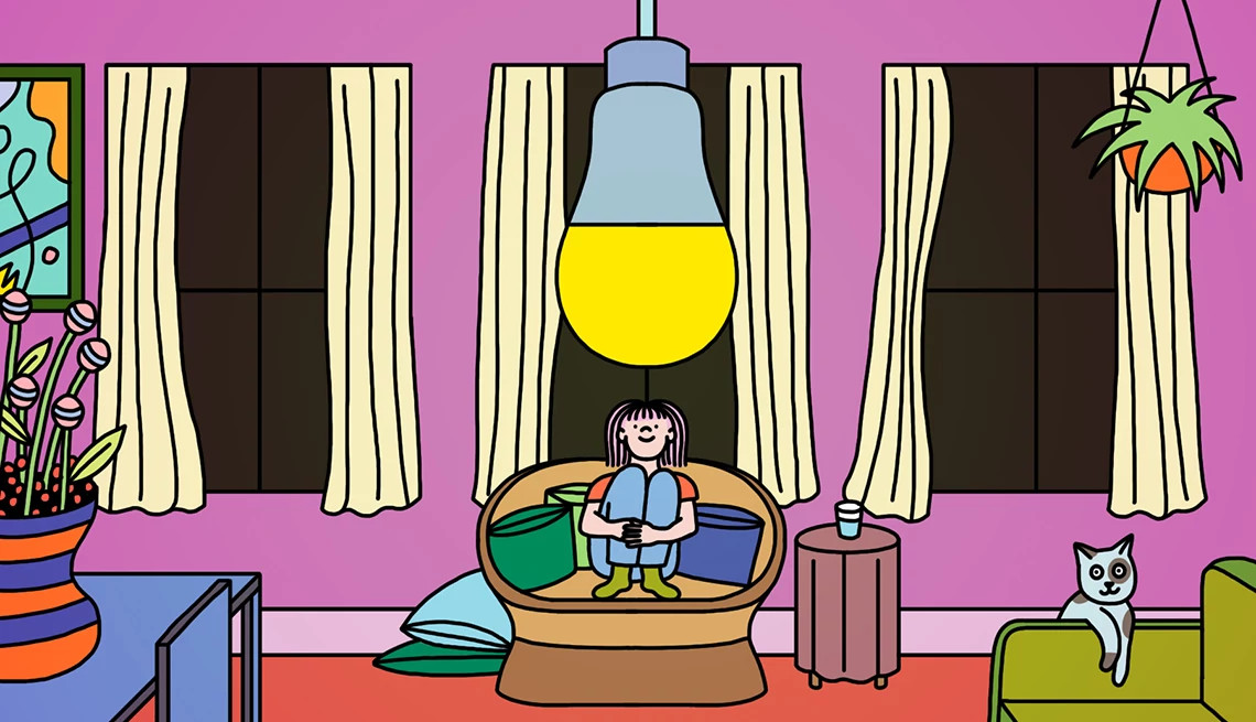 illustration of a person sitting on a couch with a cat nearby looking at a warm-glow lightbulb hanging from the ceiling