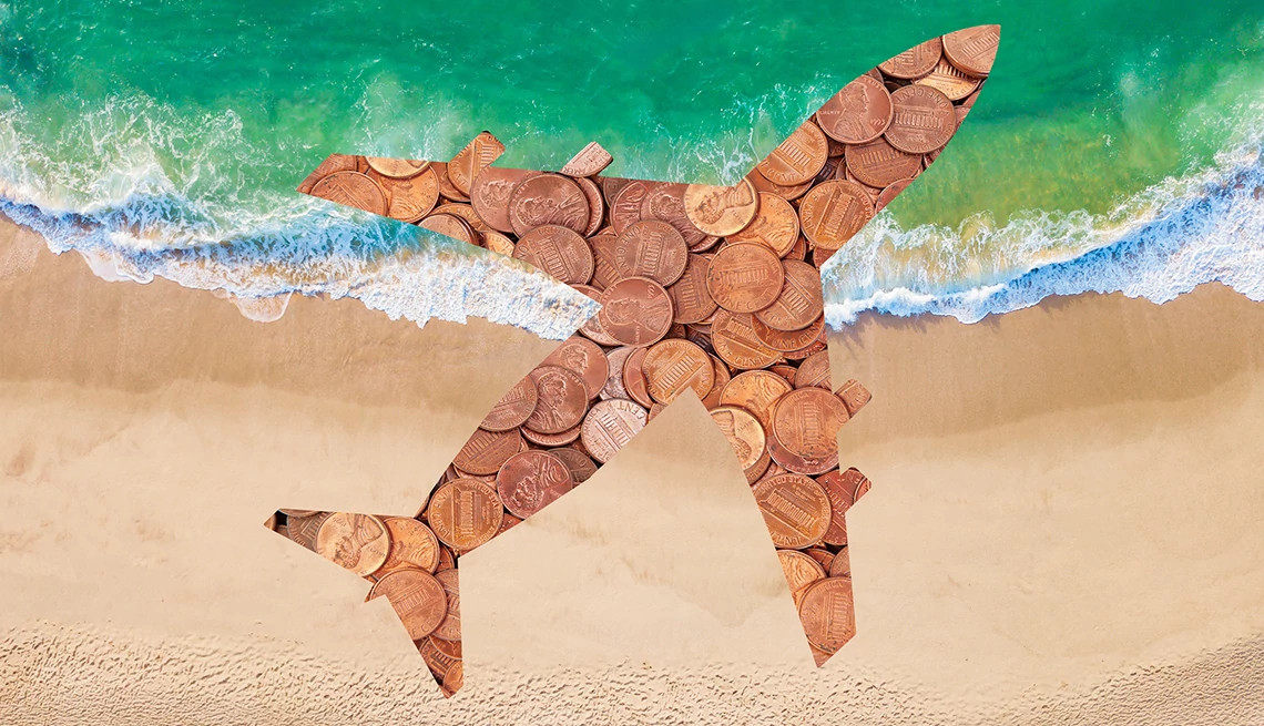 an airplane cutout filled with pennies flying over a shoreline 