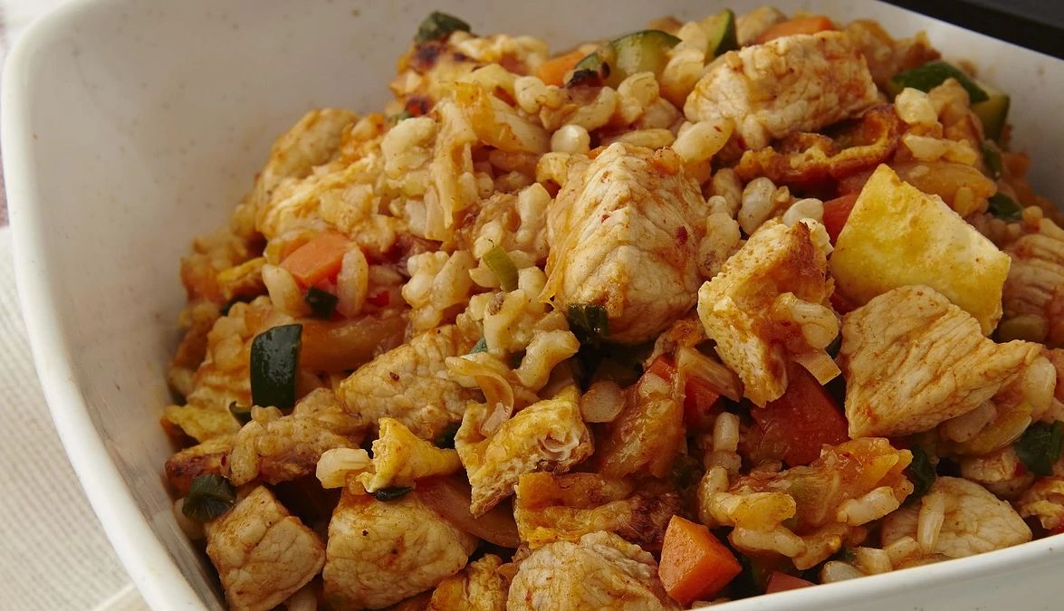 Korean pork and kimchi fried rice A close-up view of Korean pork and kimchi fried rice in a bowl