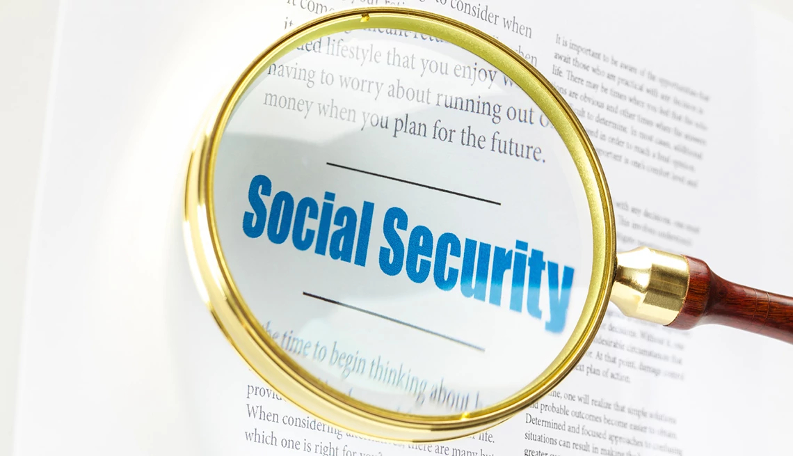 words social security in blue magnified with glass