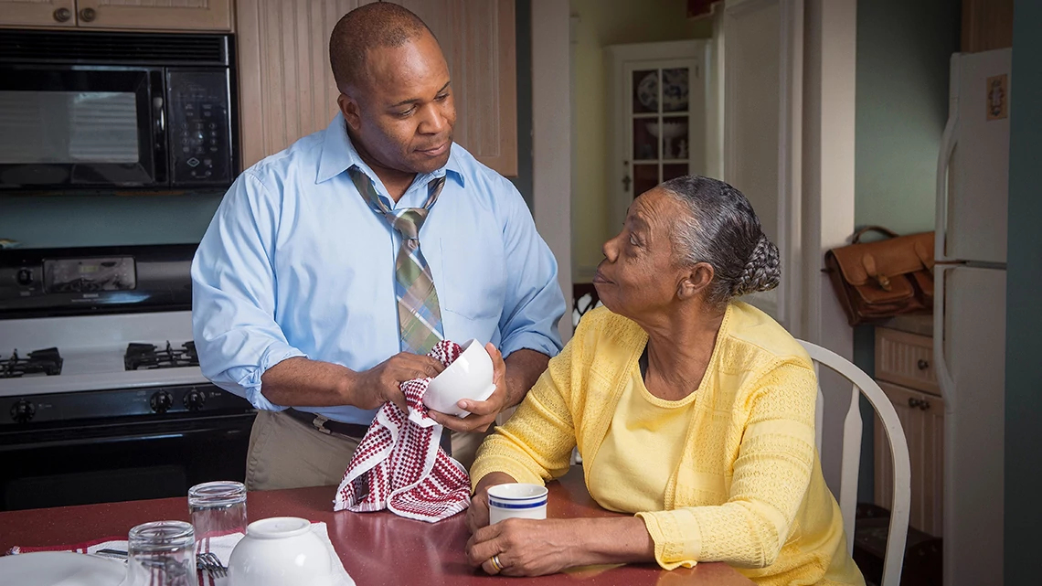 son and mother at kitchen table talking after work and dinner