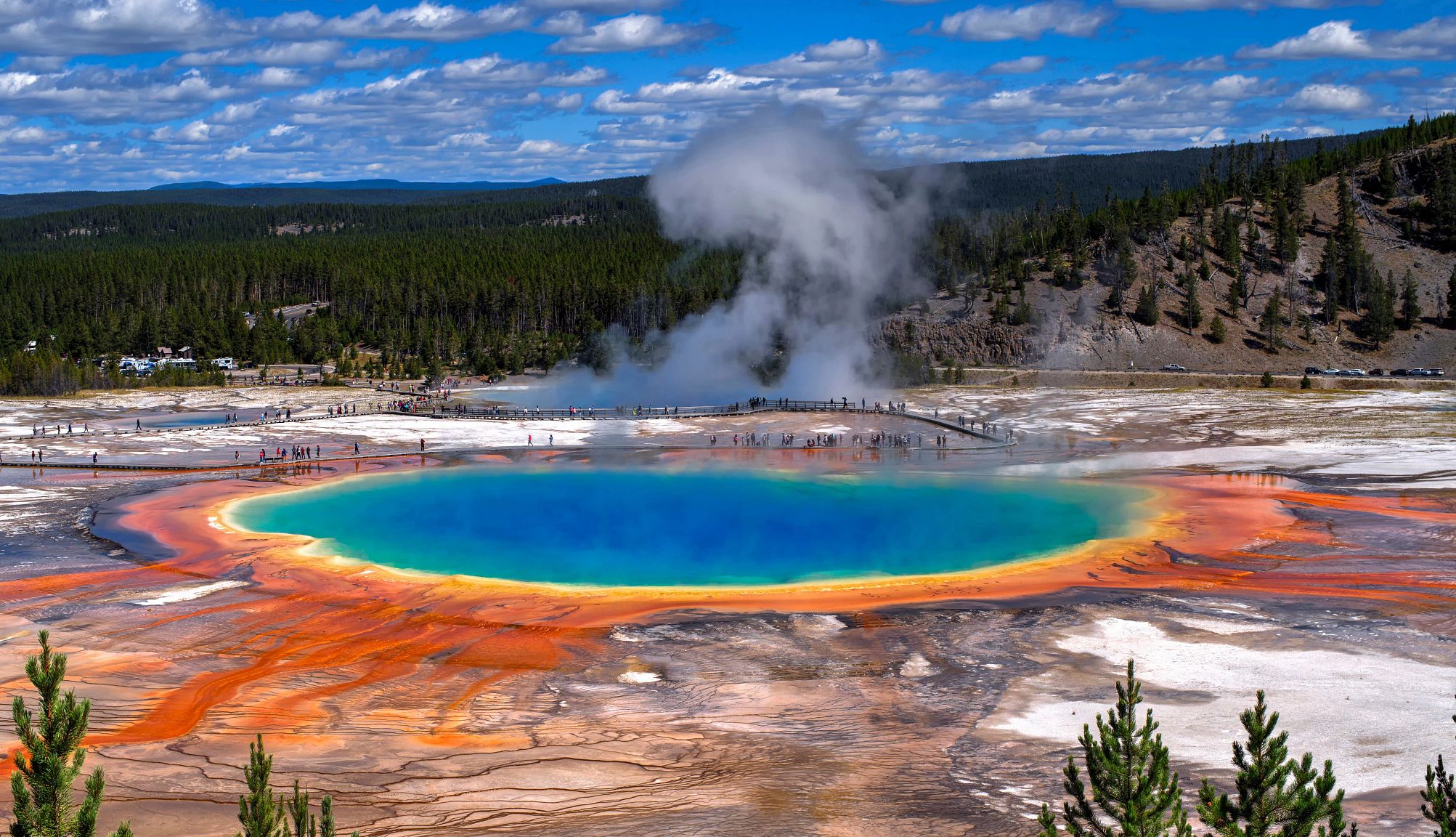 Fairy Falls Trail people look at colorful hot springs at Yellowstone National Park