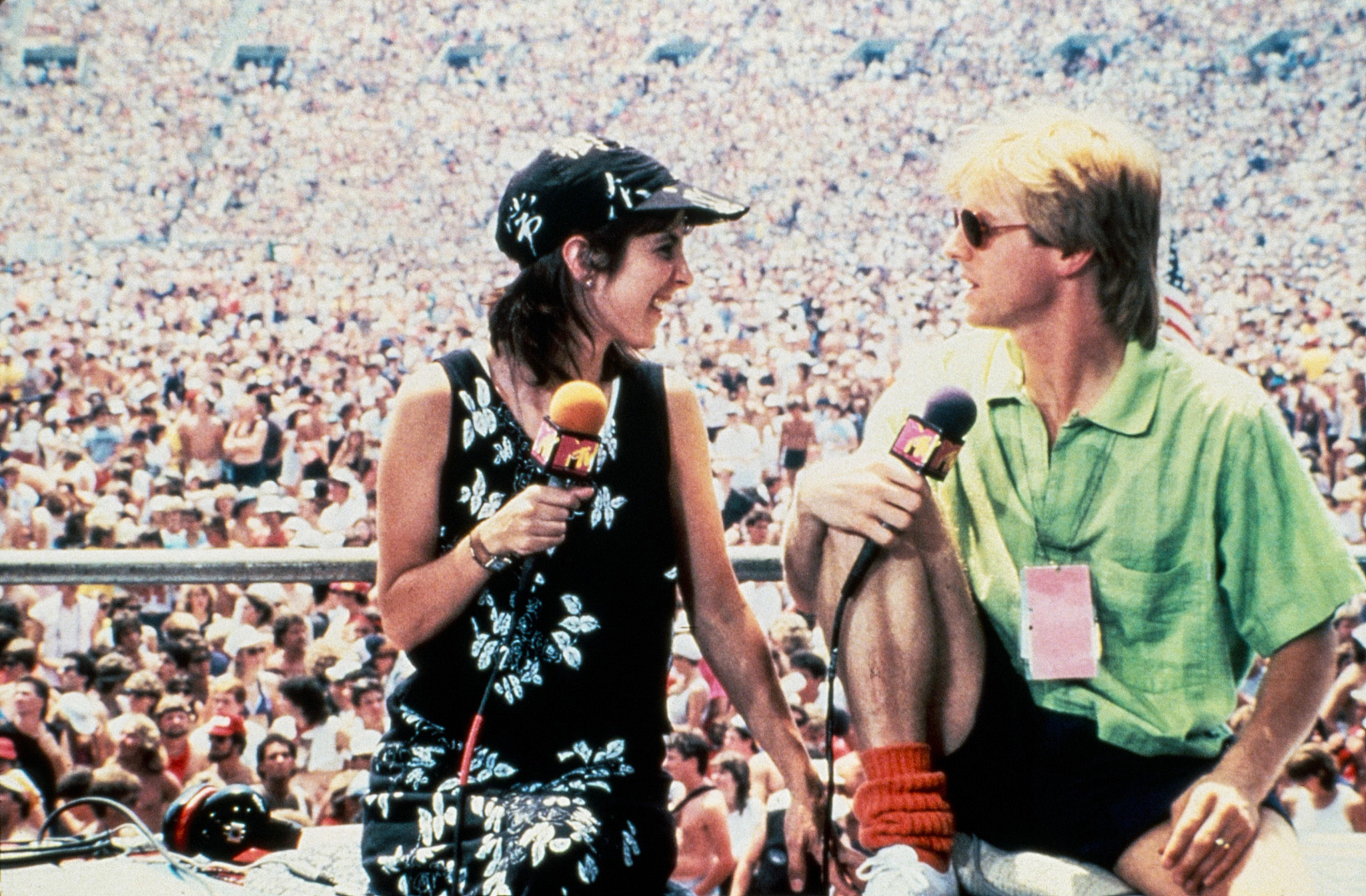 martha quinn and alan hunter in front of a huge crowd at live aid