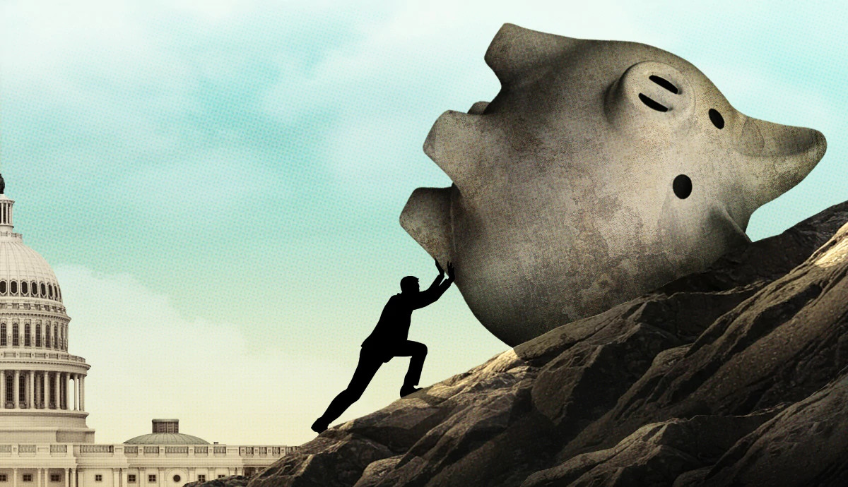 A figure pushes a giant piggy bank up a rocky hill. A capitol building sits in the background.