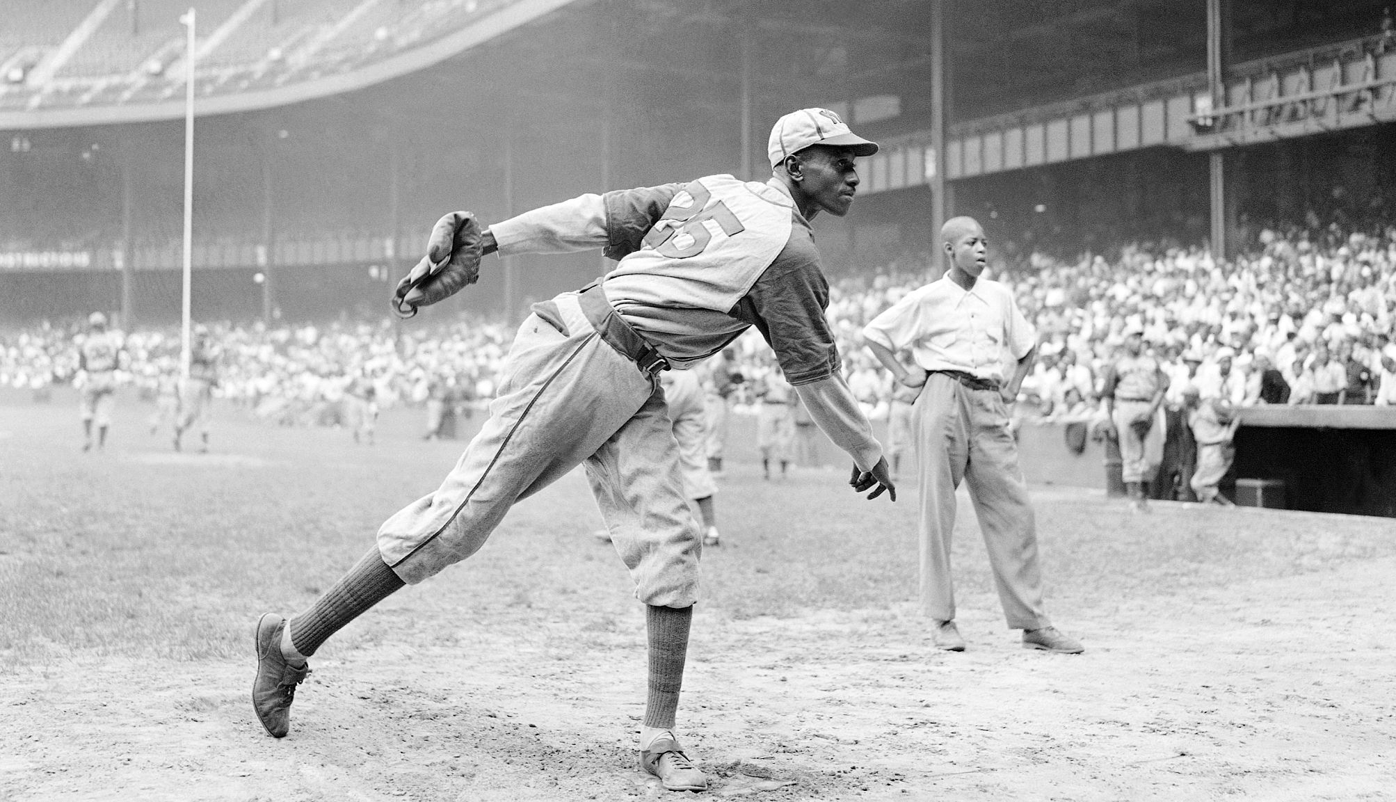 satchel paige warns up for a game in nineteen fourty two.