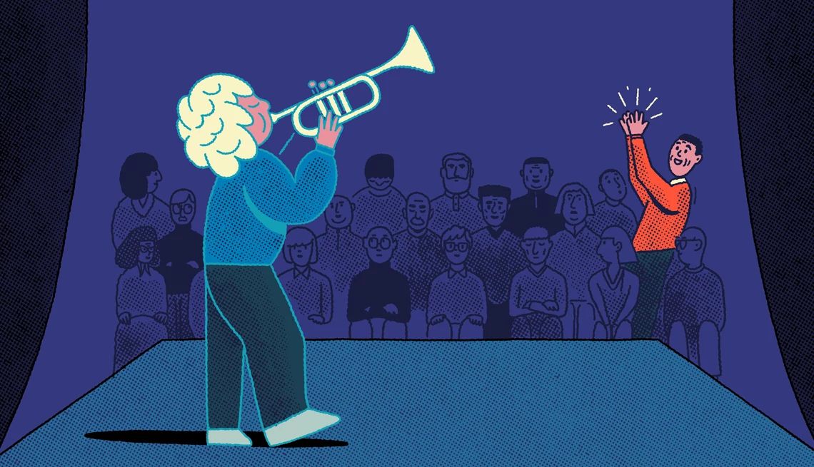 Boost Your Grandkid's Confidence a person playing a trumpet on stage with someone clapping in the crowd