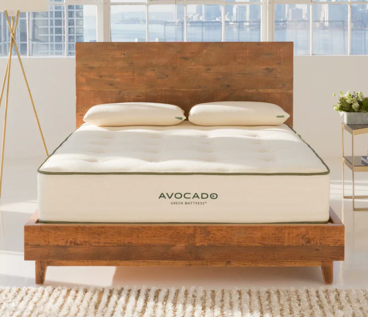 The Avocado Green on a wooden bedframe in a city apartment